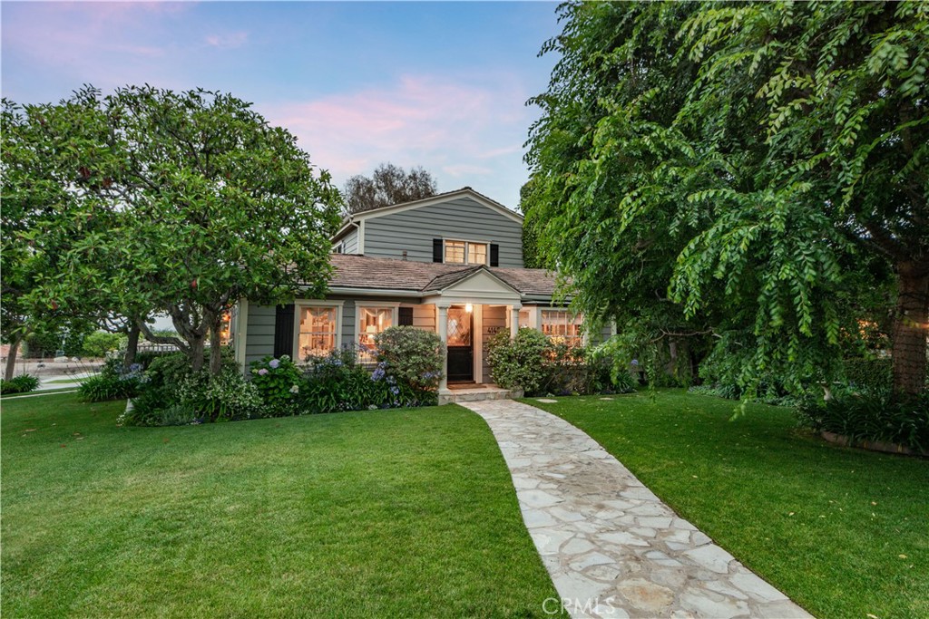 Set on an expansive corner lot in the highly sought-after Valmonte neighborhood, this iconic Cape Cod-style residence seamlessly combines timeless elegance with luxurious modern living.
A classic Dutch door with leaded glass opens to a warm and inviting interior. The light-filled living room features a wood-burning fireplace, bay window, and a built-in surround sound entertainment system. A secluded guest bedroom and full bath on the main level offer privacy and comfort for visitors or in-laws.
The formal dining room is ideal for entertaining, with seating for up to 12 and custom corner built-ins that add charm and function. The gourmet kitchen is a chef’s dream—appointed with a Viking range and griddle, double ovens, dual dishwashers, marble countertops, limestone center island, and premium stainless steel appliances.
Just off the kitchen, a cozy den offers the perfect spot to relax or read, with French doors that open to a spacious side yard and PV stone patio—ideal for seamless indoor-outdoor living.
The resort-style backyard is a true retreat, featuring a sparkling pool and spa, built-in grill, fire pit, and a beautifully manicured lawn.
Upstairs, the expansive primary suite enjoys sweeping city lights views, vaulted beam ceilings, Pine hardwood floors, and a comfortable sitting area. Antique 8-foot Belgian wood doors lead to a luxurious primary bath with dark Emperor marble floors, Nu Heat radiant heating, a Jacuzzi tub, an oversized walk-in shower with dual showerheads, and a vast walk-in closet.
A separate children’s wing includes a playroom and a full bathroom. Additional features include custom hand-crafted cabinetry, new central A/C, and an attached 2-car garage.
This rare Valmonte gem offers a perfect blend of classic Cape Cod style and stylish California living.