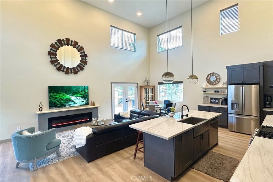 Elevate your lifestyle ~ Set yourself apart with this newly built 2023 custom mountain residence, where exceptional design, comfort, and breathtaking views come together in perfect harmony ~ Ideally located just 15 minutes from all of Big Bear’s year-round amenities ~ This spacious home offers the perfect balance of seclusion and accessibility ~ Step inside to be greeted by soaring high ceilings and an open floor plan bathed in natural light ~ The inviting interior features high-end finishes throughout, including custom natural quartzite countertops, sleek stainless steel appliances, hand painted solid wood base boards and thoughtful touches that elevate everyday living ~ The expansive great room seamlessly connects to the kitchen and dining area, creating an ideal flow for entertaining or unwinding in style ~ The home’s exterior is just as impressive, enjoy sunrise coffee or sunset cocktails from the large front and back decks, or take in the crisp mountain air from the private upstairs balcony off the game room ~ Whether you're relaxing or hosting guests, every corner of this home was designed to capture the surrounding mountain beauty ~ An attached garage and additional storage shed provide ample space for all your mountain toys from snowboards to climbing equipment, as well boat and jeep parking ~ The adjacent lot can potentially be included in the sale at the right price, the possibilities to expand or simply enjoy extra space and privacy are yours to explore ~ Whether you're seeking a primary residence or a luxurious second home this one-of-a-kind property delivers both elegance and opportunity ~ Experience the finest of mountain living in this custom-built move-in ready home ~ its waiting for you to create endless memories with your family and friends.