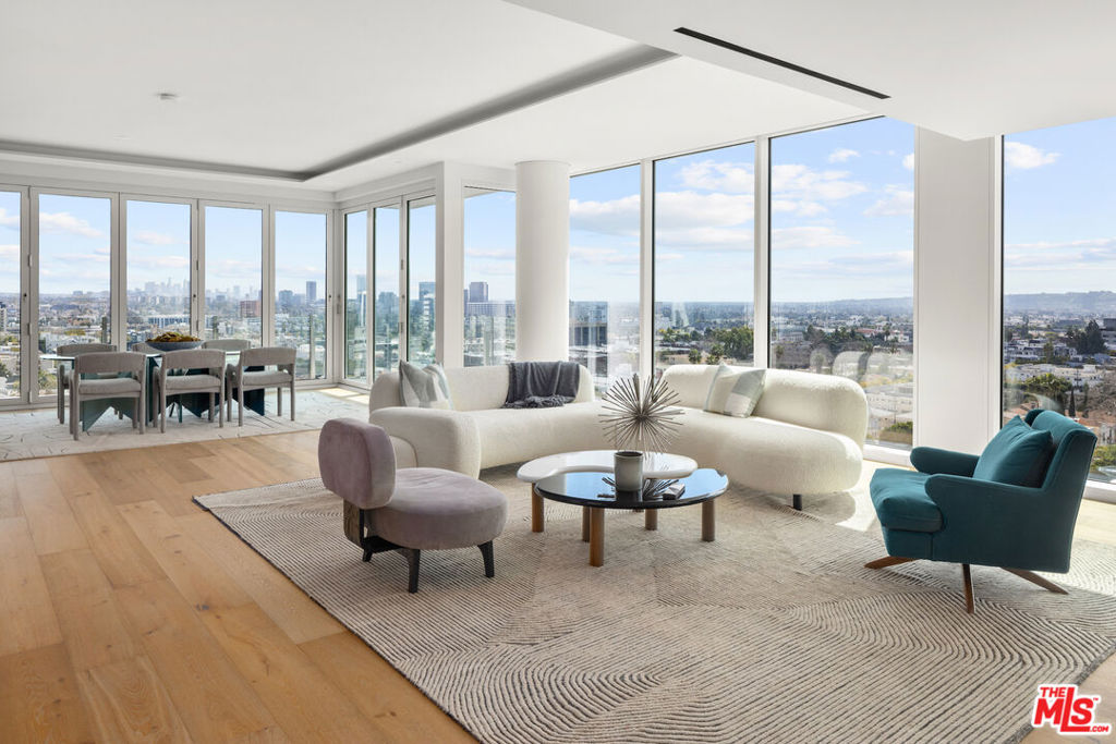 Sub-Penthouse 1102 (aka 11B) of the Four Seasons Private Residences Los Angeles. This nearly 5,000 square foot estate in the sky boasts unparalleled, unobstructed 270 degrees city lights, ocean and landmark views of Los Angeles. recently custom built out with high design, this 2-bedroom (which could be easily converted into a 3-bedroom) residence features wide plank white oak floors, wrap-around walls of glass, a boutique-sized primary closet, phenomenal entertaining space, and two spacious balconies which provide an enviable indoor-outdoor flow by way of accordion panels of glass. Enter the residence directly through private, secured elevator access from the lobby or garage level (where you can store your vehicles in your private 4-car garage). Towering above its neighbors and set in a coveted central location adjacent to the iconic Four Seasons Hotel, the Four Seasons Private Residences Los Angeles is a limited collection of 59 residences ranging from one- to four-bedroom homes, priced from $2.75M to $27M. Set within a distinctive, newly-built 13-story building, the residences offer living spaces steeped in California Modern style with custom interiors by Martyn Lawrence Bullard, chef-caliber kitchens with Gaggenau appliances, and spa-like baths. Crafted to maximize L.A.'s sought-after indoor-outdoor living, every residence is bathed in an abundance of year-round Southern California golden light, and many of the residences boast a rooftop garden, an open-air terrace and/or sweeping views of the city. Residents of the Four Seasons Private Residences Los Angeles enjoy an unrivaled, service-rich lifestyle with five-star onsite services, including world-class concierge, in-residence dining and housekeeping, plus a private, saltwater pool with cabanas, a 19-seat IMAX Private Theatre Palais and lounge, a Harley Pasternak-designed Fitness Center, a residents' lounge, and more.