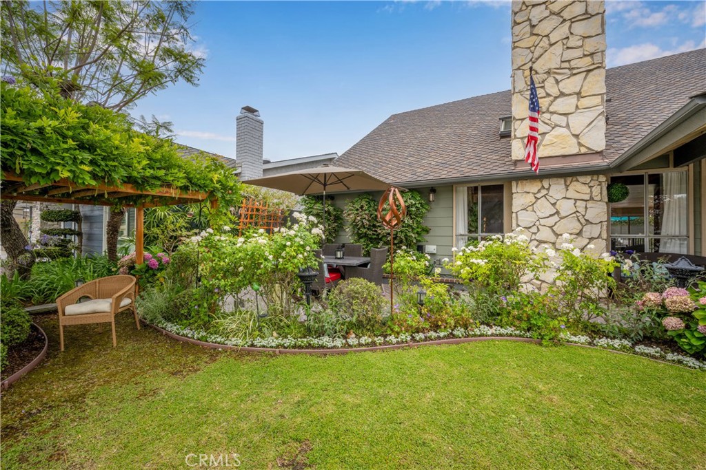 Thoughtfully and meticulously designed to be an oasis of calm and beauty, this Greenbrook Spacemaker II is a classic California design at once open and adaptable: an expansive 2,807 sq ft with 5 bedrooms and 4 bathrooms. Lovingly maintained and professionally decorated, this home has been fashioned for family living. Enter into a lovely raised entry featuring elegant terrazzo flooring, then step down into a spectacular formal living room with a dramatic beamed vaulted ceiling, vented skylights, wall sconces, luxury carpet, hand-painted mural, and a custom gas fireplace. The balcony on the second floor has been designed as a home library overlooking the living room, featuring built-in shelving and storage space, and a cozy reading nook filled with natural light. The family room is multi-functional for everyday living and relaxing at the wet bar, open to the kitchen with window walls for a lovely garden view. The original kitchen, large and open for family gatherings, boasts brand new fridge, built in microwave, and electric range/ oven, as well as freshly painted cabinetry and new hardware. Originally designed as a formal dining room, the den off the kitchen is ideal for watching movies, playing games, or relaxing with a book. Downstairs are 3 bedrooms: a large primary suite with private bath, 2 additional bedrooms, and a beautifully finished bathroom. Upstairs are two bedrooms, one of them extra large, two bathrooms, an attic with plywood flooring for storage, a bonus room with skylight, two children’s lofts, and a loft library with space for a home office. The remodeled garage is currently a workspace with maple veneer custom cabinets and track lighting. The interior garage door leads to the utility room with dedicated laundry space, pantry, and utility closet. The backyard features an expansive patio and lawn making for a fabulous summer with colorful landscaping, seating areas, and a catio. The beautiful front yard provides amazing curb appeal, starting with the herringbone patterned brick patio, water-smart landscaping, and charming front porch. The owner has invested in countless upgrades including: new electric panels, new carpet, new vinyl plank flooring, brand new HVAC system, upgraded baths, new roller shades, new plants and shrubs, new mirrored closet doors, professionally designed color palette and fixtures, and the entire interior freshly painted. This home has been lovingly appointed and cared for, waiting for you to make it your own!