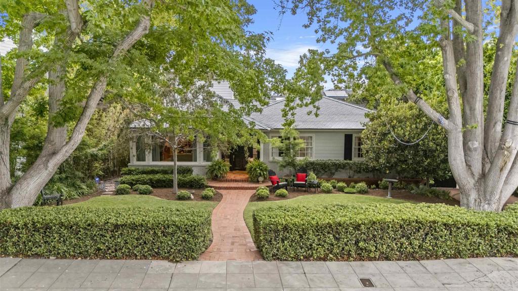 Timeless Elegance on Upper Hermosa’s Most Coveted Street~Nestled on the most desirable street in Upper Hermosa—celebrated for its iconic July 4th and Halloween festivities—this 5-bedroom, 4-bath home offers 3,356 square feet of thoughtfully designed living space on a generous 10,400 square foot lot. Framed by two majestic Liquidambar trees, the home welcomes you with a classic brick entry and a light-filled foyer that sets the tone for the warmth and sophistication found throughout. Maple flooring runs through most of the home, while two bedrooms retain their original oak flooring and charming French windows, blending timeless character with classic architectural detail. The professionally designed kitchen is a true showpiece, featuring sleek Poggenpohl cabinetry, both induction and gas cooking, a handmade cast glass counter, Corian and soapstone surfaces, and a Sub-Zero professional-grade refrigerator. A custom-built wood wall feature and counter sculpture highlight the area with artistry and intention. Two ensuite bedrooms offer peaceful, private retreats with custom finishes. An additional 5th bedroom showcases soaring 12-foot ceilings and bespoke windows, creating a striking architectural focal point. Skylights throughout flood the home with natural light, enhancing its inviting atmosphere. The spacious two-car garage can double as a game room or entertainment space, providing flexible use options. The outdoor spaces are equally impressive. A huge side yard with custom gate offers endless potential for play or entertaining. A custom Ipe deck sits beneath a louvered pergola, adjacent to a custom wooden ceiling and a quartz-stone patio all surrounded by blooming roses. The expansive organic garden features mature fruit trees. A walking path behind the backyard invites leisurely strolls and a connection to the surrounding neighborhood charm. More than just a home, this is a rare opportunity to live in one of La Jolla’s most cherished neighborhoods—where timeless elegance, vibrant community spirit, and thoughtful design come together in perfect harmony.