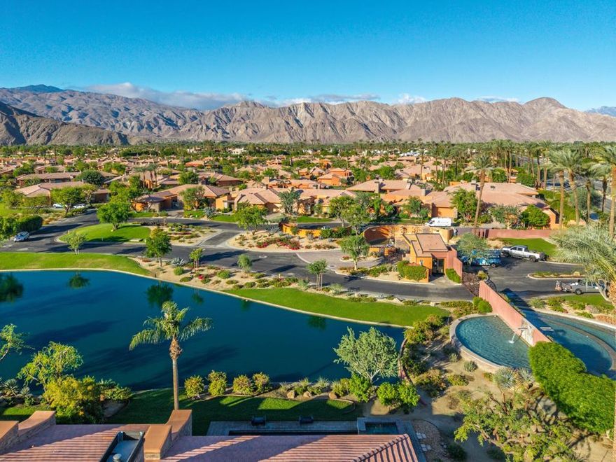 Lakefront Luxury with Panoramic Mountain Views in Palmilla.This stunning Palo Brea model home offers one of the most spectacular, unobstructed southwest-facing views of the Santa Rosa Mountains in Palmilla--with no homes across the lake for exceptional privacy. Spanning 3,278 square feet, this residence showcases refined upgrades and seamless indoor-outdoor living.The open-concept kitchen, dining, and living areas are framed by walls of floor-to-ceiling sliding glass doors that expand to the patio, pool, and shimmering lake beyond, completely erasing the boundary between indoors and out and creating a true indoor/outdoor living experience. Custom cabinetry enhances the living room, kitchen, and closets, while a stone-accent fireplace, wet bar, and designer fixtures elevate the home's sophistication.Two spacious primary bedroom suites provide luxurious comfort, and a flexible third bedroom--currently used as an office--opens to a serene private courtyard patio. From the primary suite, take in awe-inspiring panoramas of the mountains and lake, redefining luxury desert living. Outdoors, enjoy resort-style amenities including a built-in barbecue island, large pool and spa with a water feature, citrus trees, and professional landscape lighting.Additional highlights include high-end appliances, custom window treatments, a 2-car plus golf cart garage, and meticulously selected hardware throughout.Architecturally acclaimed Palmilla is an exclusive, 24-hour guard-gated community featuring just 152 single-family homes. This enclave showcases an eye-catching blend of modern and craftsman-style architecture, thoughtfully designed to harmonize with its stunning natural surroundings.Nestled among shimmering lakes and custom-crafted metal artwork, Palmilla offers residents a serene and artful environment. The community enjoys direct, private golf cart access to The Citrus Golf Club--one of the area's premier courses--providing effortless opportunities to enjoy world-class golfing just moments from home.