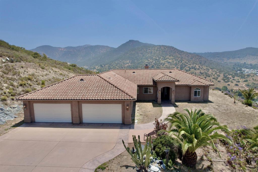 LOCATION! LOCATION! THIS HOUSE IS IN BLOSSOM VALLEY AREA, CLOSE TO 8 FWY with VIEWS! This ranch style custom-designed masterpiece, nestled on a sprawling 4.42 acres, invites you into a world of luxury and comfort. 1,200 Sqft ADU CAN BE BUILT AND 500 Sqft JUNIOR ADU !!! NO HOA, NO MELLO-ROOS. This single-level home, perched atop the world, boasts a fabulous gourmet kitchen that is a culinary enthusiast's dream, cathedral ceilings, featuring top-of-the-line stainless steel appliances, granite counters, and a spacious island perfect for entertaining. With 4 bedrooms and 4 bathrooms, including a dreamy master suite with an extra-large walk-in closet, this residence exudes elegance and thoughtful design. The panoramic views from every corner of the house are absolutely stunning, providing a constant backdrop of natural beauty. The long driveway leads you up and away to this fine estate, ensuring privacy and a sense of retreat. Revel in the beauty of every sunset from the comfort of your own home. The well-thought-out floor plan enhances the flow of the living spaces, making it an ideal haven for both relaxation and entertainment. The property also features a 4-car garage, RV parking, and ample space for all your toys and horses, ADU/Guest house, catering to the needs of the modern homeowner. Don't miss the chance to make this exceptional property your own and experience the epitome of luxurious living with breathtaking views and unparalleled amenities. LOCATION! LOCATION! THIS HOUSE IS IN BLOSSOM VALLEY AREA, CLOSE TO 8 FWY with VIEWS! This ranch style custom-designed masterpiece, nestled on a sprawling 4.42 acres, invites you into a world of luxury and comfort. 1,200 Sqft ADU CAN BE BUILT AND 500 Sqft JUNIOR ADU !!! NO HOA, NO MELLO-ROOS. This single-level home, perched atop the world, boasts a fabulous gourmet kitchen that is a culinary enthusiast's dream, cathedral ceilings, featuring top-of-the-line stainless steel appliances, granite counters, and a spacious island perfect for entertaining. With 4 bedrooms and 4 bathrooms, including a dreamy master suite with an extra-large walk-in closet, this residence exudes elegance and thoughtful design. The panoramic views from every corner of the house are absolutely stunning, providing a constant backdrop of natural beauty. The long driveway leads you up and away to this fine estate, ensuring privacy and a sense of retreat. Revel in the beauty of every sunset from the comfort of your own home. The well-thought-out floor plan enhances the flow of the living spaces, making it an ideal haven for both relaxation and entertainment. The property also features a 4-car garage, RV parking, and ample space for all your toys and horses, ADU/Guest house, catering to the needs of the modern homeowner. Don't miss the chance to make this exceptional property your own and experience the epitome of luxurious living with breathtaking views and unparalleled amenities.