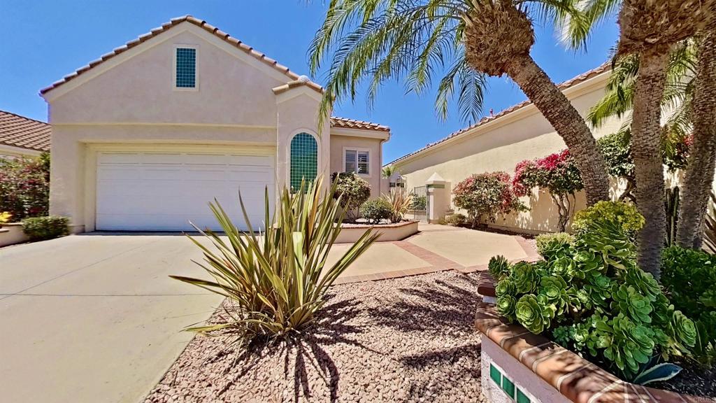 Welcome to The Fairways at Lake San Marcos — one of North County’s most cherished communities, where panoramic views, coastal breezes, and refined living create the perfect setting for a relaxed yet elegant lifestyle. Built in 1992 and thoughtfully maintained, this single-level residence sits on a gentle rise in an exclusive, guard-patrolled neighborhood. Tucked away from Rancho Santa Fe Road, the home offers peace, privacy, and a prime vantage point to enjoy its breathtaking surroundings. Inside, vaulted ceilings, expansive windows, and natural light highlight the open-concept design. The spacious living room with a cozy fireplace flows effortlessly into the dining area and kitchen—perfect for both daily comfort and entertaining. Stained-glass accents add artistic charm, while the seamless indoor-outdoor connection draws your attention to the sweeping views beyond. This desirable lot features unobstructed panoramas of lush green fairways, rolling hills, and the distant Pacific Ocean. At sunset, the sky transforms into a canvas of vibrant color—adding beauty and serenity to your everyday life. The vaulted ceiling primary bedroom offers both a walk-in closet and a sliding-door closet in the bathroom, each with built-in organizers. The en-suite bath features a soaking tub, separate shower, and new smart toilet.—creating a true private retreat. Additional highlights include an attached two-car garage with built-in cabinetry, a deep utility sink, and abundant storage. The Fairways community enhances the lifestyle with scenic walking paths, manicured green spaces, and a welcoming neighborhood feel. Residents enjoy a heated pool and spa, along with 24-hour security patrol. For a minimal fee, you may also join the Lake San Marcos amenities, including two more pools, a spa, tennis and pickleball courts, kayaking, fishing, and a vibrant lakefront clubhouse. Perfectly located, this home is minutes from fine dining, boutique shopping, sandy beaches, and endless recreational opportunities. Whether you’re searching for a full-time residence or a peaceful second home, this property combines comfort, elegance, and unforgettable views in one of San Diego’s most desirable hidden gems.