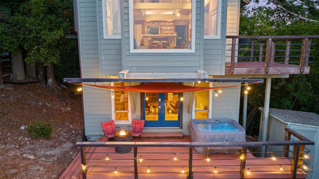 Wake up to towering redwoods, shimmering bay views, and quiet you can actually hear. Tucked in Santa Cruz County's Happy Valley, this 3.6-acre retreat pairs everyday convenience with a true mountain-meets-coast lifestyle. You're in the Happy Valley Elementary one-school district, small, close-knit, and uniquely community-focused, while still moments from town. Weekends write themselves: hike the old-growth groves at Henry Cowell Redwoods State Park, then be on the sand or downtown Santa Cruz in minutes. When you need errands (or a movie and dinner), Scotts Valley has easy shopping, groceries, and the local cinema just 5 minutes away. Commuters and day-trippers will appreciate direct access toward Santa Cruz and Highway 17 via Branciforte Drive (one of the primary routes serving the Happy Valley area) placing Los Gatos and coastal workplaces within straightforward reach. Inside, nearly 2,000 sq ft of sun-splashed living blends open-beam ceilings, skylights, and a modern kitchen that opens to view decks, perfect for morning coffee above the trees or easy entertaining at sunset. With sun and privacy galore, plus a flexible space for home office or media, this is a home that lives like a sanctuary without giving up access to everything you love about Santa Cruz living.