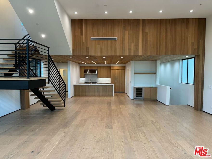 Welcome to this spacious three-bedroom, two-and-a-half-bath modern townhome crafted in 2021. Nestled in the heart of Venice, this 2,916 sqft residence offers fresh, light-filled interiors with wide-plank hardwood floors and soaring ceilings. A welcoming living area with a fireplace flows seamlessly into the open dining space and chef's kitchen, equipped with a convenient breakfast bar and premium stainless appliances. The luxurious primary suite occupies its own floor, featuring a spa-like bathroom with dual vanities, a rainfall shower, and ample closet space. Two additional bedrooms on the entry level offer flexibility for guests, a home office, or a private retreat. Panoramic city and mountain views extend from the top-floor rooftop deck ideal setting for sunset gatherings or simply enjoying coastal breezes. With central heating and air conditioning, plus in-unit laundry, comfort is built in. Two assigned parking spaces complete this turnkey home. Just blocks from Abbot Kinney's vibrant shops and eateries, and moments from the beach, this move-in-ready condo brings upscale living and ultimate convenience together. Don't miss the chance to call this condo your home!