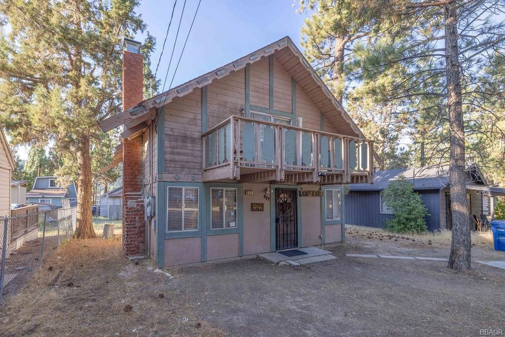 This inviting chalet-style home features two oversized bedrooms, two updated bathrooms, and a spacious loft that can serve as a third bedroom, game room, or home office. A main-level bedroom offers the ease of single-level living, while the upstairs bath boasts a deluxe steam shower--nice for relaxing after a day of mountain adventures. The updated kitchen showcases granite countertops and flows into a cozy living area centered around a classic wood-burning fireplace, for chilly evenings. Recent upgrades include a mini split inverter A/C, a 240-amp electrical panel to accommodate modern needs, as well as a newer water heater and wall heater. Set on a large, level 5,000 sq ft lot, this home offers ample parking and room to expand. Step outside to enjoy two upper decks--one off the bedroom and one off the loft--for sipping morning coffee or stargazing under the mountain sky. Located just minutes from Big Bear Lake, Snow Summit, Bear Mountain, and the Village, this property is your gateway to year-round outdoor recreation--whether it's hiking, biking, skiing, or simply unwinding in nature.