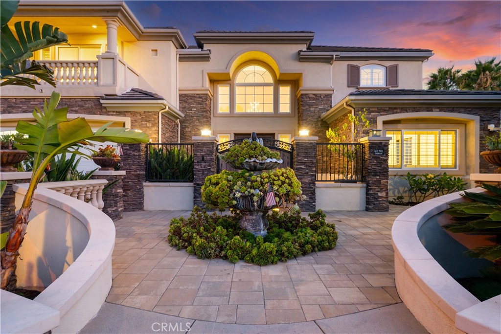 Exquisite Toll Brothers estate in the prestigious Amalfi Hills community of Yorba Linda. This expanded luxury residence offers 6 bedrooms and 6.5 baths on over 30,000 square feet of lot. Originally 5,826 square feet, the home has been thoughtfully enhanced with permitted additions, including a private upstairs gym, office, additional ensuite bedroom and California room, bringing the total to nearly 6,600 square feet of refined living space.
The grand entry welcomes with soaring ceilings, sparkling crystal chandeliers, all-tile flooring, marble molding, striking marble pillars, a travertine accent wall, and marble fireplace. Indoor/outdoor living is highlighted by lanai sliding doors and a custom dual-panel retractable screen system with blackout and mesh options. Crystal lighting throughout enhances the timeless elegance.
The Show kitchen features premium granite countertops, all Miele built-in appliances including coffee maker, microwave, 6-burner range with oven, designer hood, dishwasher, and an 8-ft floor-to-ceiling wine and beverage cooler. A separate chef’s prep kitchen with Samsung appliances provides additional convenience for entertaining.
Two en-suite bedrooms are located downstairs. Upstairs, one wing is dedicated entirely to the primary retreat with panoramic views, private gym, office, movie lounge, and a spa-inspired bathroom featuring a custom round soaking tub. The opposite wing offers three ensuite guest rooms, creating a thoughtful and private layout for all.
Resort-style outdoor living includes a pool with water wall and connected heated spa, outdoor fireplace, built-in BBQ, putting green, custom fire pit lounge, and ample seating areas and RV/boat parking.
Upgrades include fully paid solar, two new AC condensers, two tankless water heaters, whole-home water softener, and EV charger. Feng shui elements are thoughtfully integrated throughout the property.
Located in North Yorba Linda Hills with award-winning schools, this estate is a rare combination of architectural beauty, modern efficiency, and turnkey modern living. Come see and appreciate your new home...see the video walk-through!!!