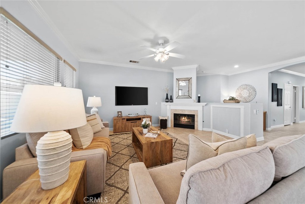 This beautifully maintained Trento model is located in The Oasis, Menifee’s premier 55 plus gated community. The home features a welcoming front porch, spacious open floor plan, and a remodeled chef’s kitchen with granite countertops, full backsplash, pull-out shelving, and a raised island with seating. The great room includes a fireplace with a custom mantel and flows seamlessly into the living and dining areas. A flexible bonus room with custom built-ins and French doors offers space for a formal dining room, office, or optional third bedroom.
Interior upgrades include crown molding, updated interior paint, tile flooring in living areas, vinyl plank floors in bedrooms, and custom baseboards. The primary suite offers tray ceilings and a fully updated bath with a redesigned walk-in shower, quartz counters, and custom cabinetry. The garage has extra space for a workshop or golf cart parking.
Enjoy the private backyard with water-wise landscaping, vinyl fencing, Alumawood patio cover, AstroTurf, and sun screens. Newer HVAC included. HOA covers front yard landscaping, water, and trash. No Mello Roos taxes. Conveniently located near shopping, dining, golf, and all that the Menifee Valley has to offer.