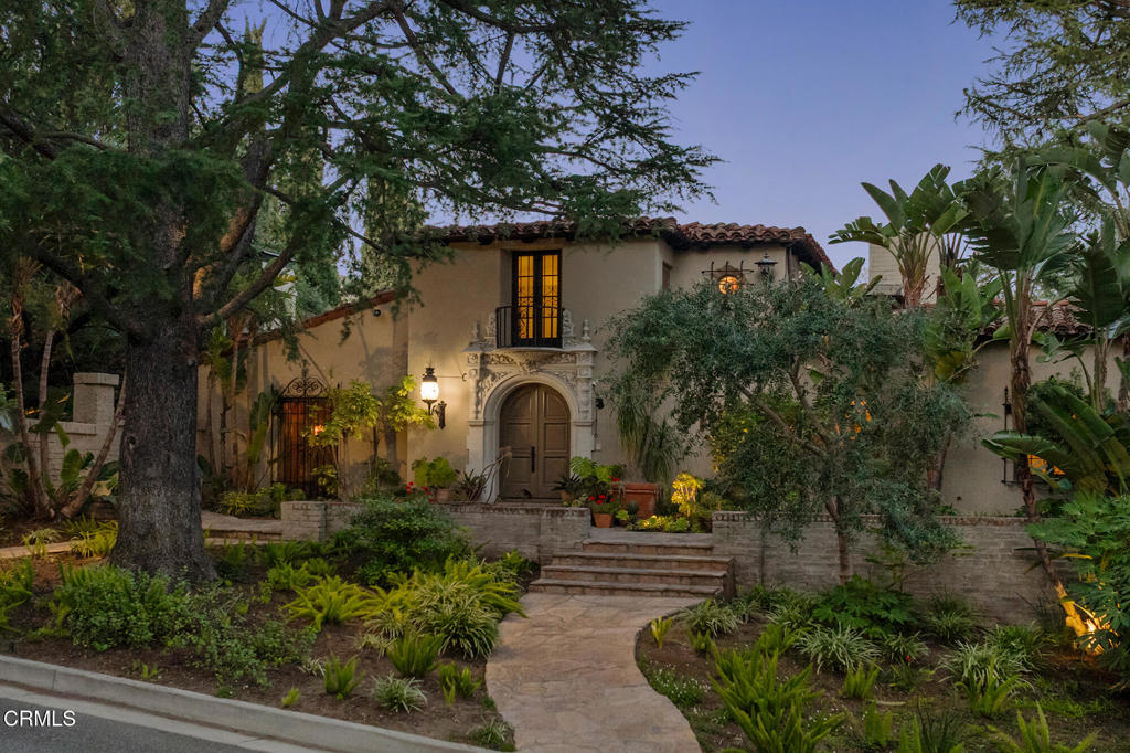 Quintessential 1927 Mediterranean Revival by the trailblazing Paul R. Williams, FAIA. A collection of architectural and horticultural grandeur including restored primary estate residence, light-flooded guest Casita and Guest House with 3-story observatory - set among towering specimen trees, acclaimed gardens and an olympic-size pool on 1.2 acres in the Alta Canyada Estates area of La Canada. Entrance of bas relief decorations, silversmith-style finials, tapered columns and balcony with classical underside shell motif. Paneled library and ladies lounge flank the foyer and grand reception solarium, with black and white marble floor, 20 foot ceilings accented with coffered panels, and arched french doors with views of the outdoor terrace and reflection pond with fountain. Living Room with cast-cement wide mouth fireplace and hand-painted stenciled ceiling. French doors lead to a serene terrace complete with Spanish fountain and Della-Robbia ceramic tile mosaic. Separate music room adjacent. Formal dining room with period stained glass picture scape. Kitchen, butler's pantry, den and basement with wine cellar. Primary suite with sleeping terrace, as well as his/her bathrooms. Three additional bedrooms in the main residence. A robust Spanish courtyard arcade with wrought iron plant holders, covered walkway with three Moravian star pendant lights leads to the Guest House with third story observatory - with rustic stone fireplace, bar, 2 bedrooms and 1 bathroom and attached to the 2-car garage. An additional one-bedroom Casita with kitchen and picture window floods the living room with natural light.An olympic-size pool with a broad flagstone deck anchors the expansive grounds. A plethora of plant species, meandering paths, patios and water features abound. Whimsical faux bois Tea house designed in 1929 by a Japanese artisan. Additional outbuildings, including changing rooms service both the estate and its guests. A treasure representative of Williams' early style - personifying true grace and understated elegance.