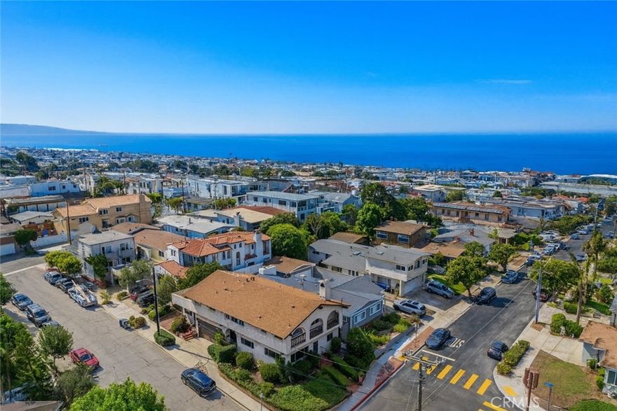 Situated on the corner of 14th Street and Church in the sought-after Martyrs section of Manhattan Beach, this single-family home offers space, versatility, and a prime location. Enjoy expansive easterly views plus a peek-a-boo of the ocean from both the front and upper level.

The main floor features three bedrooms, each with its own ensuite bath. One has been designed as a home office with wet bar and private entrance, while another bedroom includes an attached large recreation room with wet bar and its own separate entrance, creating unique options for work, guests, or flexible living. Upstairs, the open floor plan connects the kitchen, dining, and family room beneath vaulted ceilings. A powder bath and the spacious primary suite complete this level, which also opens to a large sun deck. Additional highlights include a two-car garage plus additional off-street parking. Ideal for large households, multi-generational living, or anyone seeking flexible space, this home is walking distance to downtown shops, dining, schools, and the beach, combining a prime location with exceptional potential.