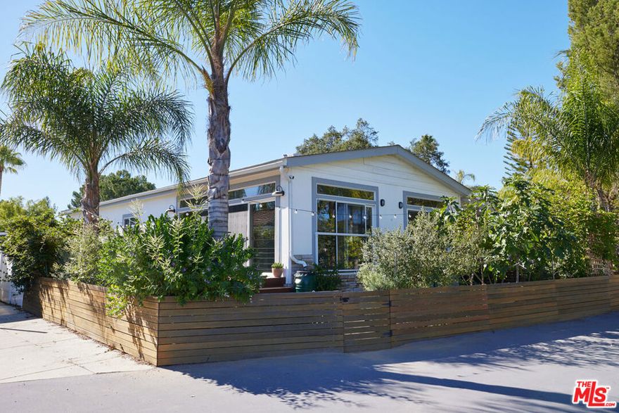 This 3-bedroom, 2-bath home in the gated community of Top O' Topanga offers sweeping views of the valley below from the deck, added last year. Natural light fills the open layout, with new flooring throughout and large windows that frame the landscape. The kitchen is spacious and inviting, with granite countertops and plenty of room to cook, gather, or simply enjoy a quiet morning as the sky shifts outside. Brand new refrigerator not shown in photos. Both bathrooms have been beautifully redone -- calming, elegant spaces that feel like your own private escape. A garden wraps around the home, with fruit trees, a small pond, grassy lawn and patio area -- providing plenty of space for entertaining or relaxing outdoors. The driveway offers up to 3 private parking spaces plus an additional storage shed/workshop.  Just across the way is the neighborhood's historic clubhouse, where you'll find a pool, spa, gym and library. There's also a dog park, kids' play area, hiking trails, and plenty of guest parking. A peaceful spot that feels miles away, but you're close to Malibu, the 101, and everything in Woodland Hills and Santa Monica.