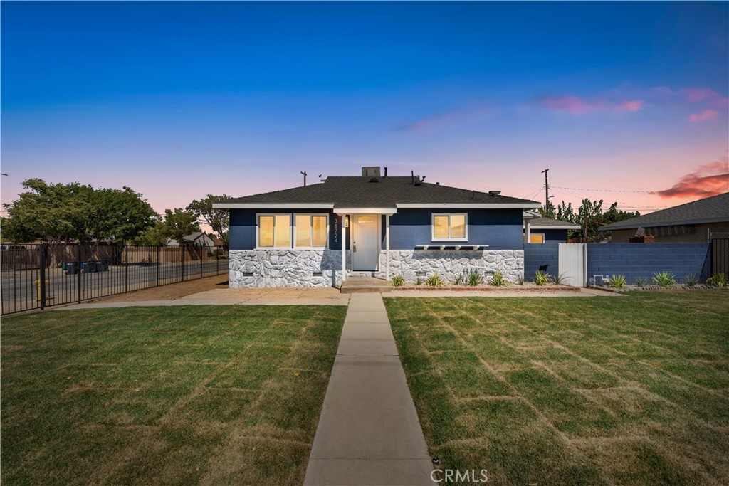 Beautifully Renovated 1950s Corner-Lot Gem! This fully updated 3-bedroom, 2-bathroom home offers modern comfort while retaining its timeless charm. Situated on a spacious corner lot, the 1,020 sq. ft. residence has been thoughtfully remodeled from top to bottom. Step inside to discover new waterproof vinyl flooring, new vinyl windows, and fresh interior & exterior paint. The open-concept kitchen boasts all-new shaker cabinets, quartz countertops, stainless steel appliances, single-basin sink, and recessed lighting—perfect for cooking and entertaining. The kitchen flows seamlessly into the inviting family room, creating a warm gathering space. Both bathrooms have been completely refreshed with new tubs/showers, vanities, toilets, and modern light fixtures. The primary suite offers a private on-suite bath for your convenience. Upgrades include new PEX plumbing, upgraded electrical panel, new wall furnace, and a newer roof, ensuring worry-free living. Outside, enjoy a newly landscaped enclosed front yard with irrigation, a large, fenced backyard with alley access, and a 2-car garage with laundry hookups and a new door/opener. Move-in ready, energy-efficient, and loaded with updates—this home is ready for its next chapter.