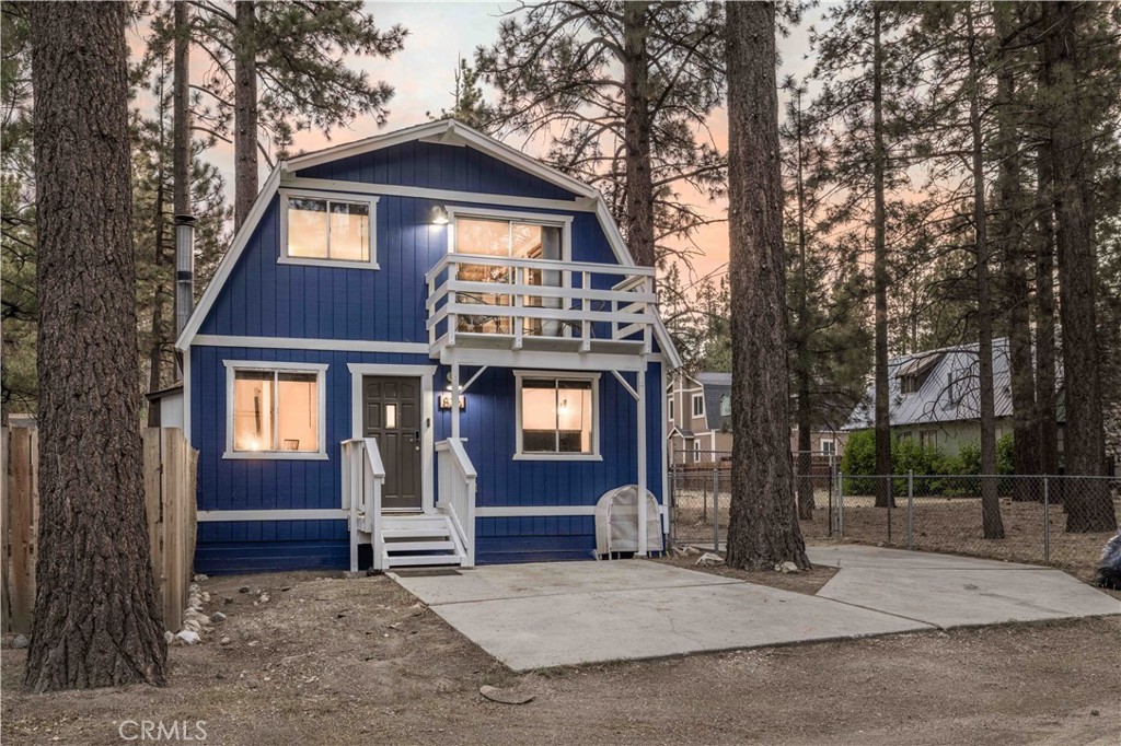 Tucked at the end of a quiet street in Big Bear City, this light and bright retreat offers stunning views and is surrounded by pines. The open living area features a native stone fireplace, wood accents, and a fully recently renovated kitchen with quartz counters, newer appliances, and open breakfast bar, ideal for entertaining. Upstairs, two spacious bedrooms boast vaulted ceilings, abundant light, and views from a private deck. A bonus detached room adds flexibility as an office, studio, or third bedroom. The spacious patio is ideal for dining or lounging while taking in the mountain air. Enjoy extra storage in the detached garage and ample room for parking or storing toys in the gated driveway. Turnkey, close to hiking, skiing, the village, dining, and shopping, ideal as a full-time home, vacation getaway, or income rental.