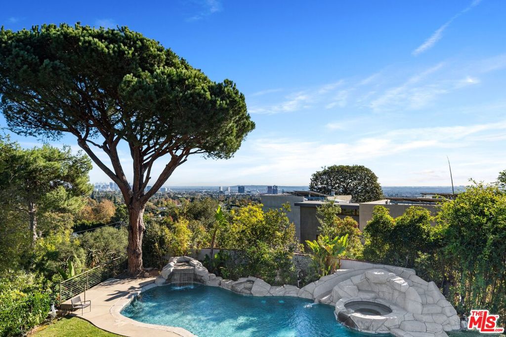 Incredible opportunity to live in a resort-style home with the most amazing Pacific Ocean and City Views. This bright, open-planned house is in a very serene area of Brentwood. The gourmet kitchen features chef-grade appliances including a Sub-Zero refrigerator and Miele espresso machine. There is also a huge wine refrigerator. Spacious living, dining and family room on the first floor with an onyx stone-framed dual fireplace. The primary bedroom has a walk-in closet. 4 en-suite bedrooms located upstairs with a spacious 2nd family room. This home is minutes away from Brentwood Country Mart, exclusive fine restaurants and a shopping center. Experience the true leisurely life. Easy to show.