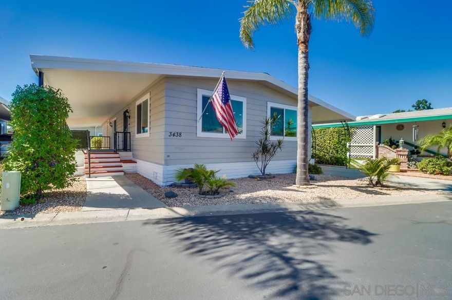 Remodeled inside and out in 2025! Beautifully updated manufactured home in one of the best locations in Rancho Carlsbad. Views out to the golf course and rolling hills. Large covered deck and private backyard with fruit trees. Interior and exterior of this home were extensively remodeled with high end materials to create a serene and neutral living space. New windows and slider door. Freshly painted inside and out. Can recessed lighting installed and new drywall throughout home.  Kitchen was opened up to create an eat in island and open concept flow to the dining and family rooms.  Both bathrooms were tastefully remodeled and include new fixtures, new showers, free standing vanities and a built in make-up station in the primary with ample storage. Move in and start enjoying the sought after 55 plus community amenities including golf course, clubhouse, tennis and pickleball courts, community pool, sauna, gym, hot tub, ping pong, dog park, RV storage and more. You own the land and pay NO SPACE RENT. 24 hour guard gate and onsite management. Only minutes from Carlsbad Village and the beach. Includes a generous carport for parking and a bonus room that could be used as a shed, storage or workroom. See supplement for upgrade details. This is the one you have been waiting for!  Remodeled inside and out in 2025! Beautifully updated manufactured home in one of the best locations in Rancho Carlsbad. Views out to the golf course and rolling hills. Large covered deck and private backyard with fruit trees. Interior and exterior of this home were extensively remodeled with high end materials to create a serene and neutral living space. New windows and slider door. Freshly painted inside and out. Can recessed lighting installed and new drywall  throughout home.  Kitchen was opened up to create an eat in island and open concept flow to the dining and family rooms.  Both bathrooms were tastefully remodeled and include new plumbing fixtures, new showers, free standing vanities and a built in make-up station in the primary with ample storage. Move in and start enjoying the sought after 55 plus community amenities including golf course, clubhouse, tennis and pickleball courts, community pool, sauna, gym, hot tub, ping pong, dog park, RV storage and more. You own the land and pay NO SPACE RENT. 24 hour guard gate and onsite management. Only minutes from Carlsbad Village and the beach. Includes a generous carport for parking and a bonus room that could be used as a shed, storage or workroom. See supplement for upgrade details. This is the one you have been waiting for!