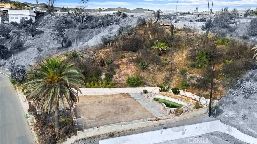 Discover this exceptional half-acre lot in Pacific Palisades, perfectly perched on its own level. This parcel offers unmatched seclusion and breathtaking Catalina views on a clear day, as well as full ocean views from many areas and rooms. Fully certified completion of Phases 1 and 2 by the Army Corps of Engineers.



Spanning nearly 24,000 square feet, the lot is ideal for a large home with expansive outdoor living areas, including patios and landscaped gardens. The existing former footprint is approximately 3,000 square feet, allowing for up to 6,000 square feet on two levels. The gently sloping hillside is highly accessible, featuring established trails that lead to a scenic hilltop vista and tranquil rest spot. Additionally, there is potential to extend the build area into the hillside, providing unique opportunities for creative design and functional use of the terrain. A sizable mid-century modern pool remains on-site, awaiting refinement to become a stunning outdoor centerpiece.



Situated just moments from the future and newly reconstructed Marquez School, the property offers convenient access to scenic walking trails, panoramic vistas, and outdoor recreation. Elevated above street level, the parcel ensures complete privacy, with no neighboring properties on either side, making it an ideal blank canvas to realize your dream home in one of the most prestigious neighborhoods in Pacific Palisades.