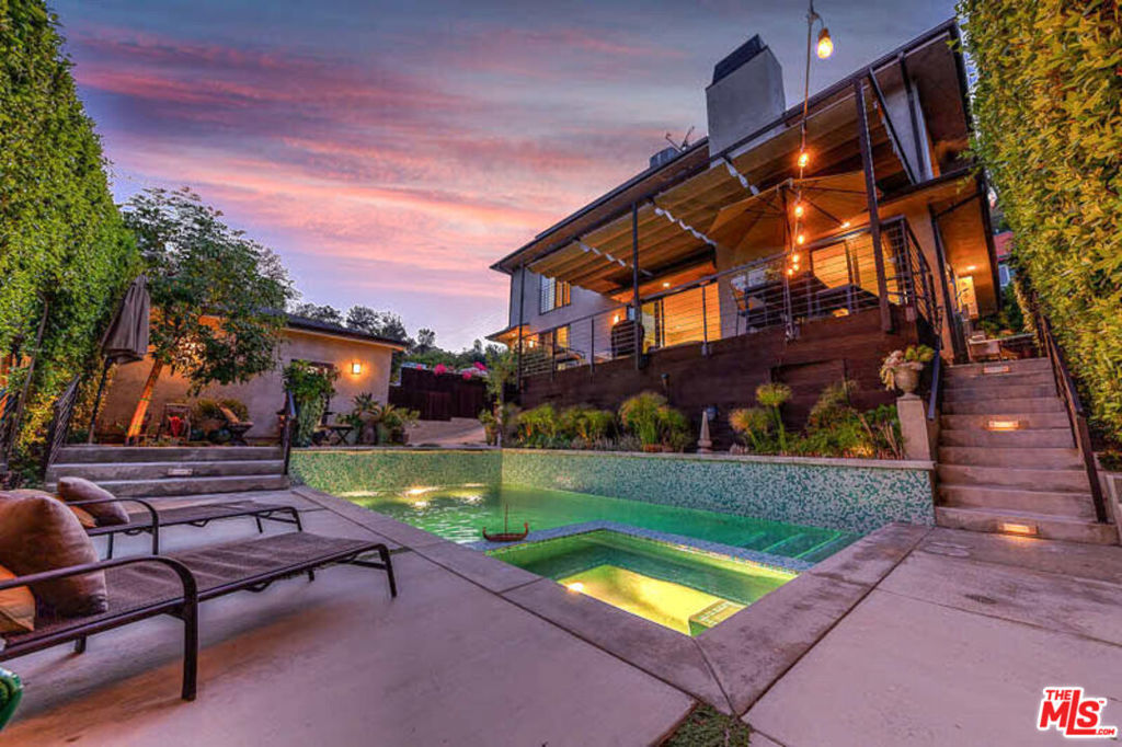 This unfurnished stunning gated contemporary compound offers 2BR & den + separate office area with secluded pool/spa & serene canyon views. Grand entry with soaring ceilings leads you to an open floor plan highlighted by beautiful walnut floors, granite fireplace and sliding walls of glass allowing access to a large deck overlooking the pool, ideal for entertaining. Cook's kitchen includes granite counter tops, Walker Zanger marble backsplash, SS appliances and wine cooler. TV/den, powder room and a guest bedroom with en-suite bath complete the 1st floor. The second level opens to a loft style office with custom built-in desk, bookshelves and a cozy bonus room. Sumptuous master suite is completed by dual vanity sinks, heated floors and oversized jet-tub. Exquisite imported fixtures and finishes throughout, Nuvo Audio System, entertainer's paradise pool and spa along with gated driveway, two car garage and additional off-street parking makes this a rare find in the Hollywood Hills.