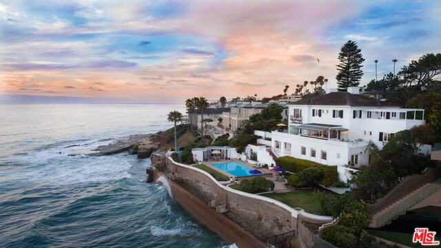 Seller will entertain offers between $16,200,000-$17,500,000. Timeless Elegance is what describes this Legendary Early Hollywood Grandeur Living Oceanfront Estate. With 170 SqFt of Spectacular Oceanfront and a very rare Beach Access Easement (ask Listing Agt for details), this Magical Estate is unlike any other homes on the market. Glorious loggias & terraces throughout the Estate with Spectacular Ocean Views and soothing Ocean sounds. Sun, Surf & Sip. The poolside cabana offers welcoming shade & a convenient Kitchenette. This grand Estate built in the early 1940's welcomes you back in time. Traditional Grand Foyer with Crystal Chandeliers, wood oak flooring. Classic Sitting Parlor, Formal Living & Dining Room overlooking the Pacific Ocean. Compartmentalized Chef's Kitchen. Formal Main Suites with separate Sitting Parlors and separate Bathrooms. Lower level boasts, a Bonus Room, Gym, Sauna, Elevator, Dumb Waiters, extra storage rooms & Wine Vault.