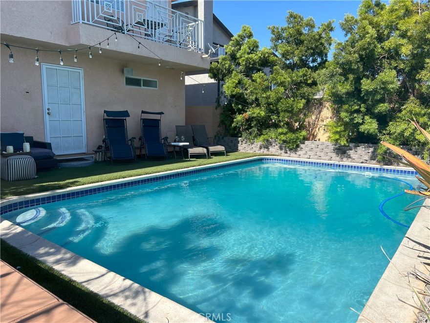 Welcome to your pool home near downtown San Pedro and the redevelopment of the port entrainment area, this amazing residence is nestled on a generous R2 lot and offers a spacious and comfortable living space spanning 1,960 square feet. With its thoughtfully designed layout, 3 bedrooms, and 2 bathrooms, this home is perfect for creating lasting memories with your loved ones. There is an extra room that is used as the 4th bedroom but could also be used as an office. As you enter, you'll be greeted by an abundance of natural light flooding through the vaulted ceilings. The master bedroom suite features a walk-in closet with a double sink vanity and a rain shower in the master bathroom. The master bedroom has direct access to the backyard oasis. Upstairs you have two bedrooms with direct access to the outdoor balcony overlooking the pool. The kitchen, which opens to the dining area off of the living room, allows for effortless entertaining and provides a warm and inviting atmosphere for gatherings with plenty of cabinetry and custom epoxy granite countertops. For those seeking a cozy retreat, the family room boasts vaulted ceilings. As you approach the front, you'll be greeted by a captivating garden and trees, adding a touch of nature's beauty to your daily life. The backyard is truly a homeowner's paradise, boasting a sparkling blue pool surrounded by trees and outdoor turf. The expansive yard is perfect for outdoor relaxation and entertaining on warm summer days. This outdoor space offers limitless possibilities for creating your own personal retreat or hosting unforgettable gatherings. Inside, the home has been tastefully updated with new interior paint, breathing new life into each room. The home also features energy efficient appliances, Nest thermostat and a tankless water heater. The backyard has direct access to the alley with a private remote-controlled gate with plenty of parking space. Located in the highly sought-after San Pedro Barton Hill neighborhood area, you'll enjoy the convenience of nearby amenities, including shopping, dining, parks, and schools. The proximity to the downtown area and coastline ensures easy access to scenic beach destinations and recreational activities. Don't miss the opportunity to make this exceptional property your own. Contact us today to schedule a private tour and experience the comfortable lifestyle that awaits you in this great home with unlimited potential.