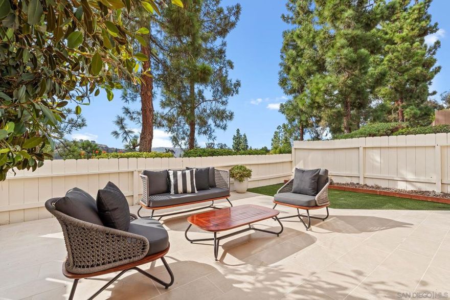 Welcome to your beautifully upgraded turn-key end-unit townhome, ready for you to move right in.  Step outside to a bright, south-facing patio—newly tiled and perfectly elevated above the walking paths. Enjoy serene views of park-like pine trees and the rolling canyons and hills of Torrey Hills.  The modern kitchen features stone countertops, tiled backsplash, and sleek stainless steel appliances—all oriented toward tranquil tree and hillside views. A sliding glass door provides direct access to the patio, ideal for entertaining with drinks and appetizers.  The living room boasts vaulted ceilings, recessed lighting, and a cozy fireplace, creating the perfect retreat for winter evenings. It opens seamlessly to the spacious patio and its sun-filled, south-facing vistas.  The bathrooms are finished in premium stone and tile, while the primary suite features a luxurious walk-in shower with dual shower heads.  Additional highlights include dual-pane windows for superior quiet and insulation, central heating and air conditioning for year-round comfort, and a new energy-efficient on-demand gas water heater. The attached garage offers generous storage space and newly refinished, sealed floors.  Enjoy resort-style living with a community pool, spa, and tennis courts, all in a beautifully maintained setting.  Located just minutes from the shops and restaurants of Piazza Carmel, One Paseo, and Del Mar Highlands, as well as top-rated schools, the library, recreation center, the SR-56 bike path, and Torrey Pines State Beach.  Experience the perfect blend of comfort, style, and location.