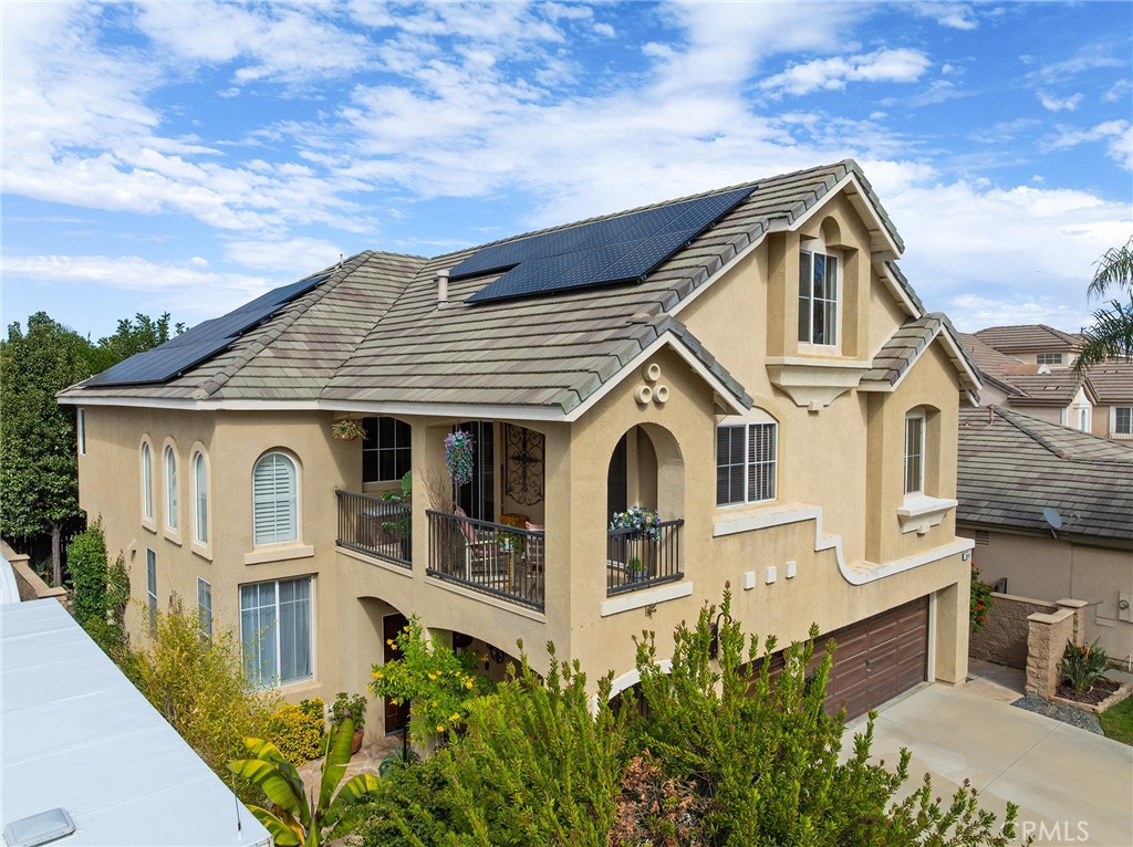 Welcome to this beautifully maintained 4-bedroom, 4-bathroom home with a 3-car garage, tucked away at the end of a quiet cul-de-sac in one of Murrieta’s most peaceful neighborhoods. Lovingly cared for by the original owners, this home blends timeless craftsmanship with thoughtful updates and family-focused comfort. The open living room showcases a stunning two-story Venetian plaster accent wall, tall windows framed with custom woodwork, and a breathtaking $40,000 custom-built second-floor library visible from below. The spacious kitchen features custom cabinetry, granite counters, stainless steel appliances, a Brizo faucet, pull-out spice racks on both sides of the oven and microwave, pull-out storage on both sides of the kitchen sink, a double trash pullout, under-cabinet lighting, and a lighted glass display cabinet. The dining room offers a coffered ceiling and crystal chandelier, while the expansive family room provides flexible space for entertaining or relaxing. Brand new hardwood flooring was installed downstairs in 2023, adding warmth and elegance throughout the main level. The main floor includes a full bathroom and an area that could easily be converted into a bedroom, ideal for guests or multi-generational living. Upstairs, the impressive primary suite spans the entire width of the home, offering space for a sitting area, gym, or office, and features a generous ensuite with dual sinks, a large soaking tub, and a spacious walk-in closet. The large bonus room includes access to a private balcony perfect for morning coffee or evening sunsets, while the third floor serves as a versatile retreat for creativity, recreation, or movie nights with a large projection wall. Enjoy the private enclosed flagstone courtyard with a split-faced stone wall, built-in fountain, timer-controlled lighting, and custom wrought-iron gates at both the courtyard and side entry. The backyard offers a gas BBQ hookup, mature trees, and lush landscaping for a peaceful outdoor retreat. Each floor has its own dedicated A/C unit for comfort and efficiency. Additional highlights include updated plumbing and electrical with 20-amp outlets in the garage and exterior, a very low-payment solar lease, plenty of storage throughout, and no HOA. Close to parks, top schools, and Temecula Wine Country, this home perfectly balances elegance, warmth, and everyday family living.