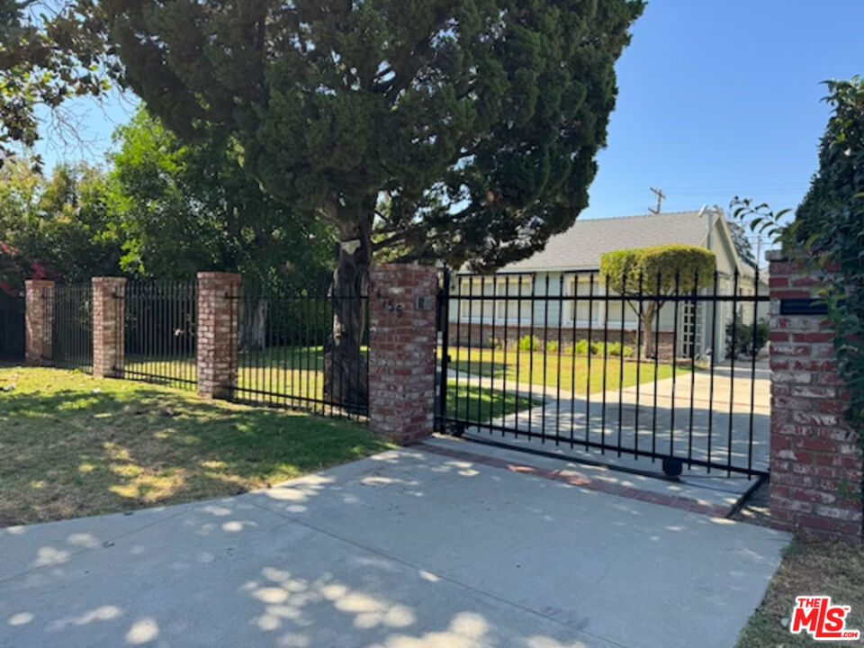 Trust Sale: Gated Ranch-Style Home with Pool, ADU Potential & Rebuild Opportunity. Unlock the possibilities with this exceptional upside. This 2-bedroom, 2-bath home features dramatic cathedral wood cedar ceilings, a statement red brick fireplace, and a bright sunroom with skylights for flexible living. Set on a generous lot with an expansive heated pool and a detached garage, the property is ideal for creating a luxurious retreat or developing an ADU. Newer Generac Generator at side of the house. With its classic bones and layout, this home invites renovation or complete redevelopment. A prime opportunity for investors, developers, or end-users seeking a custom vision in a desirable location of prime Sherman Oaks. Close proximity to the finest restaurants, shopping and transportation.