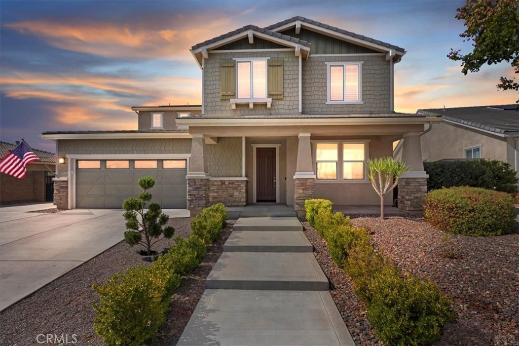 Welcome to 16951 Satsuma Avenue, a stunning hillside retreat in Riverside offering sweeping panoramic views and exceptional indoor-outdoor living. This beautifully designed home showcases incredible curb appeal with a spacious front porch and manicured landscaping, all set against the backdrop of breathtaking vistas. Inside, the home welcomes you with an airy open floor plan, abundant natural light, and elegant finishes. The living room features high ceilings and expansive windows framing the views, while the gourmet kitchen offers granite countertops, stainless steel appliances, a large center island, and ample cabinetry. A formal dining area and comfortable family spaces make this home ideal for both entertaining and everyday living. The layout includes a highly desirable downstairs bedroom and full bathroom, perfect for guests or multi-generational living. Upstairs, the primary suite is a private sanctuary with a spa-like bathroom and a balcony where you can take in the stunning mountain and city light views. Secondary bedrooms are generously sized with flexible options for family, office, or hobbies. Step outside to your entertainer’s paradise—complete with an expansive patio, an outdoor fireplace for cozy evenings, and multiple seating areas where you can enjoy the “killer view.” The backyard seamlessly blends comfort and natural beauty, offering the perfect setting for gatherings or quiet relaxation. Additional highlights include a spacious three-car garage, a well-appointed entry foyer, and a prime location near schools, shopping, and commuter routes—while still providing the privacy and tranquility of hillside living.