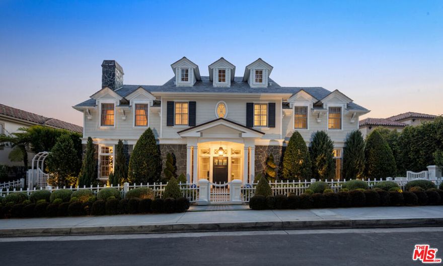 Nestled in the coveted, rapidly appreciating community of Bel Air Crest, this completely reimagined East Coast Traditional blends timeless elegance with modern sophistication. Behind guarded gates with 24/7 security, tennis courts, a clubhouse, and a true neighborhood feel, this estate offers an unmatched lifestyle in one of LA's most desirable enclaves. A grand two-story entry welcomes you into light-filled interiors featuring beautifully refinished hardwood floors, formal living and dining rooms with fireplaces, a handsome library, family room, and seamless indoor-outdoor flow through pocket doors. The gourmet kitchen is outfitted with a Sub-Zero refrigerator, La Cornue range, custom cabinetry, pantry, and a sunlit eat-in breakfast area. A smart-home system adds modern convenience throughout. Entertainment abounds with a theater, 2,000-bottle wine cellar, and children's playroom with a stage. The four-car garage with extensive built-ins plus gated motor court parking for 11 ensures ample space for family and guests. Upstairs, the primary suite features a fireplace, private sitting room, dual walk-in closets, and spa-like bath. Three additional ensuite bedrooms, upstairs laundry, and a finished attic gym with mirrored walls complete the upper level. A guest/maid's suite with private bath is located on the bottom floor, offering privacy and convenience. The backyard is a private oasis with grassy turf lawn, pool, separate spa, fire pit, and built-in barbecue bar, creating the perfect setting for entertaining.