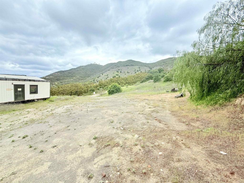 Build or Farm with a View – 7.49 Acres. Located in a peaceful agricultural zone, this 7.49-acre parcel boasts breathtaking eastern mountain views. The land was previously used as an avocado grove and still has a water meter in place, along with some existing irrigation infrastructure. A rough pad and driveway provide a head start for future development. Electricity and fire hydrants are nearby. With no HOA, no CC&Rs, and zoning that allows for manufactured homes, this is a versatile opportunity for farming, building, or both.