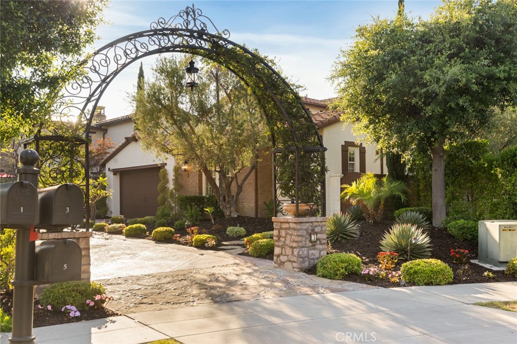 Panoramic evening light, sunset and valley views provide an ever-changing backdrop for exquisite luxury living at this magnificently upgraded Ladera Ranch estate. Located in Alisal at the end of a tree-lined cul-de-sac street behind the guard-gated entry of Covenant Hills, the home reveals its outstanding interaction with outdoor living spaces. Guests are welcomed beyond a custom arched trellis, down a long custom-finished driveway, and through a gated entry courtyard with enchanting tile wall feature. Indoors, a quest for ageless design that transcends trends and grows richer over time is immediately apparent. A rotunda foyer with inlaid tile medallion flows effortlessly to a formal living room with stone fireplace, and a formal dining room with built-in cabinetry and French doors leading to a private fireplace-warmed courtyard. Approximately 4,442 square feet, the impressively sized residence showcases a family room with fireplace, courtyard access and a seamless transition to the professionally upgraded kitchen, where new heights of culinary perfection are easily reached. Enjoy a generous island with seating, extensive white cabinetry including a built-in pantry in the breakfast nook, quartz countertops with full backsplash, a French door to the backyard, and a full suite of stainless-steel Viking appliances, including a double oven, built-in refrigerator and a six-burner cooktop with grill and matching hood. Five ensuite bedrooms and five- and one-half baths include a casita with separate entrance. The main-floor primary suite presents panoramic views, French doors opening to the backyard, and a large walk-in closet. Rivaling premium hotels, the primary bath hosts a jetted tub, separate shower, individual vanities & picture-frame mirrors. A secondary ensuite bedroom w/ view balcony awaits upstairs, where an oversized bonus room features a built-in media center and a walk-in kitchen with wet bar, granite countertops and Viking appliances. Hardwood flooring, luxurious high-end carpet in select living areas, dramatic archways, plantation shutters, upgraded lighting fixtures, and custom crown molding lend an air of sophistication throughout the residence, which also features an attached three-car garage. Gorgeous views complement a reimagined backyard, where a spa, custom walk-in BBQ bar, water-saving turf & tiled patios enhance outdoor entertaining. Covenant Hills’ private clubhouse, miles of scenic trails, & top-rated schools are just moments from home.