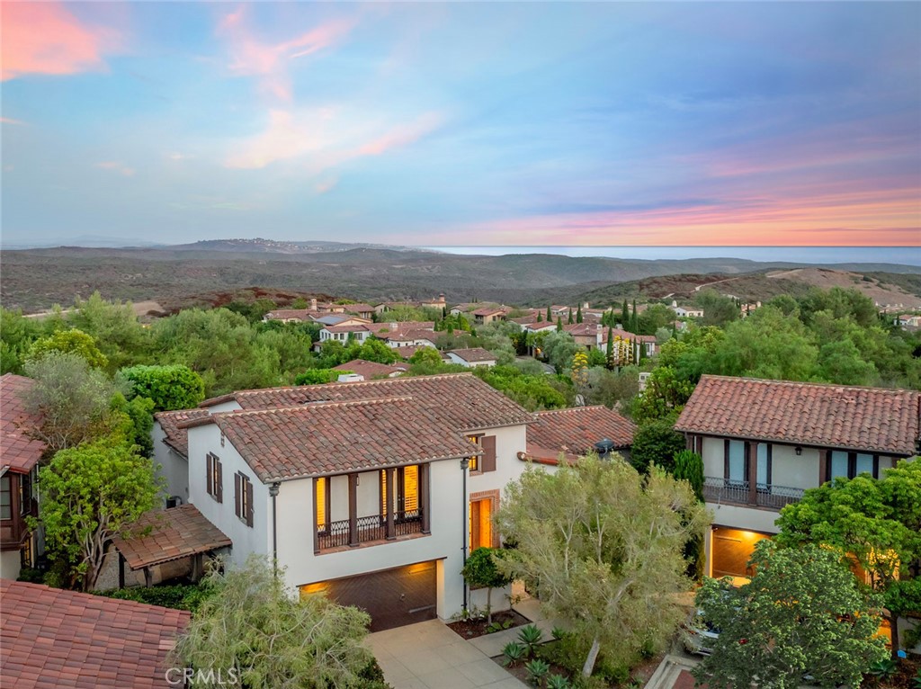 Perfectly situated FURNISHED LEASE in the prestigious guard-gated community of Pacific Ridge, this stunning residence captures sweeping views of the ocean, city lights, and rolling hills of North Laguna Beach. With approximately 3,200 square feet of thoughtfully designed living space, the home offers four bedrooms and three-and-a-half bathrooms, blending sophistication and comfort in every detail.
Expansive windows frame the stunning views and fill the home with natural light, creating a seamless connection to the outdoors. At the heart of the home, the chef’s kitchen features sleek white lacquer cabinetry, a waterfall island with bar seating, and professional-grade appliances. It flows effortlessly into the living and dining spaces, where a fireplace adds warmth and serves as a beautiful focal point for gatherings.
The MAIN LEVEL Master/Primary suite is a private sanctuary with a spa-inspired bath, custom walk-in closet, and a large retreat with wood-beamed ceilings and built-ins. Both the suite and retreat open directly to the expansive wrap-around yard, where ocean breezes and coastal views set the stage for relaxation.
Upstairs, three additional bedrooms provide comfort for family and guests, including an ensuite with a private balcony showcasing panoramic ocean and hillside vistas.
The outdoor spaces are designed for year-round living, featuring a covered loggia, built-in BBQ island with refrigerator, tranquil fountain, and lush gardens with multiple seating areas to relax, entertain, and take in the views.
This exceptional property embodies the very best of Newport Coast living, just moments from pristine beaches, scenic trails, and world-class dining and shopping. TERMS ARE NEGOTIABLE