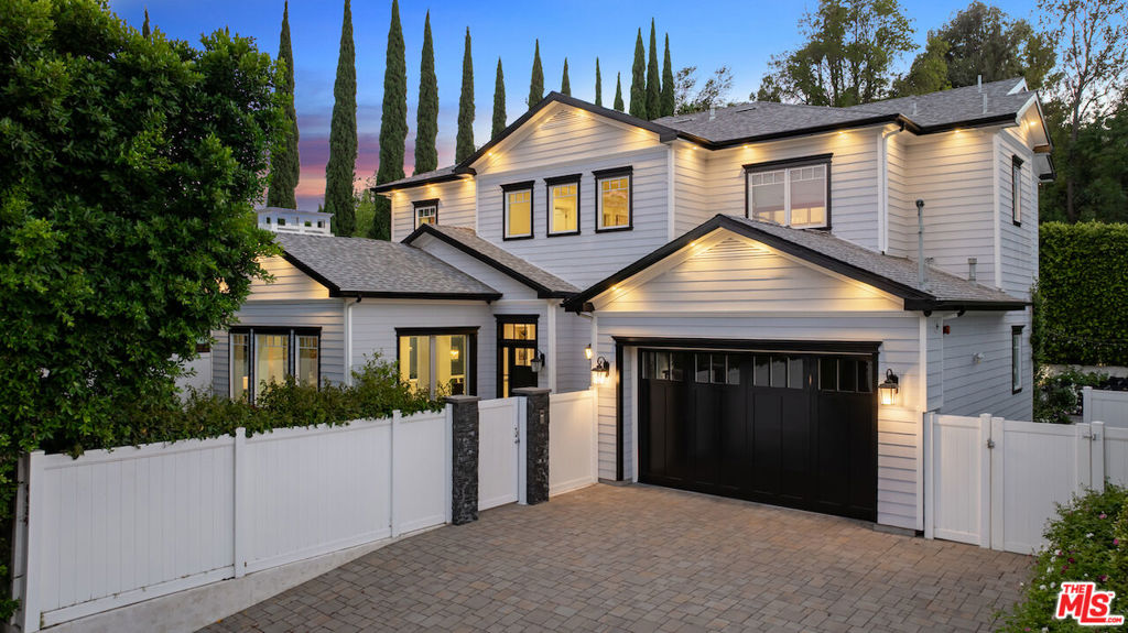 Privately tucked south of Ventura Blvd, this elegant 5 bedroom, 6 bathroom estate offers a seamless blend of timeless sophistication and modern comfort. Thoughtfully designed, the home opens with formal Living and Dining Rooms that flow effortlessly into a spacious Family Room, complete with fireplace and Fleetwood pocket doors that extend the living space to resort-style grounds. At the heart of the home, the Chef's Kitchen is both striking and functional, showcasing a dramatic marble island, custom cabinetry, professional-grade Sub-Zero/Wolf appliances including an 8-burner range and a generous walk-in pantry. Outdoors, a private grassy yard sets the stage for entertaining and relaxation alike, with a zero-edge pool and spa with cascading waterfall, multiple fire pits, built-in BBQ with sink, and covered patio for year-round enjoyment. Mature landscaping and private rose garden provide a serene finishing touch. Each bedroom includes its own ensuite bath, while the expansive Primary Suite offers a private balcony, custom walk-in closet, and spa-inspired bath with striking tile work, dual vanities, and a freestanding tub. Additional features include dual-zone air conditioning, Smart Home technology, surround sound, intercom system, LED lighting, and a security gate with cameras, all enhancing the home's modern livability. Just moments from Encino Commons, San Vicente Mountain Park trails, and convenient freeway access, this estate also lies within the highly sought-after Lanai School District delivering the perfect balance of luxury, privacy, and location.