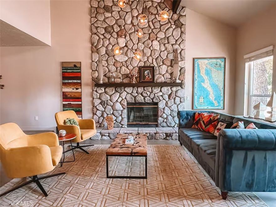 Welcome to The Lodge at Blackrock, a striking modern lodge-style residence designed by a renowned global interior designer. Located in the sought after Upper Sky Harbor on the last paved street at the top of the hill, this property is mere steps away from Joshua Tree National Park and hiking at Blackrock entrance, offering a rare blend of luxury, comfort, and iconic desert serenity.



Step inside to a grand two-story living room anchored by a massive stone wood-burning fireplace, with walls of glass framing panoramic desert and mountain views. The open floor plan flows into a formal dining area and a chef’s kitchen with premium finishes, ample counter space, and a cozy breakfast nook. A second living area with a pellet stove fireplace provides a warm and inviting retreat.



The home features 5 bedrooms (tax roll shows 4 beds - additional bed in converted dining room) and two-and-a-half baths, including a spacious primary suite with a luxury soaking tub and walk-in shower. Outdoors, relax in the 10-person “swim spa,” cool off in the cowboy tub, or gather around the fire pit under starlit desert skies. Located in a quiet neighborhood known for its natural beauty and peace, The Lodge at Blackrock offers a truly immersive desert lifestyle. Whether as a primary residence, vacation retreat, or investment property, this home checks all the boxes!