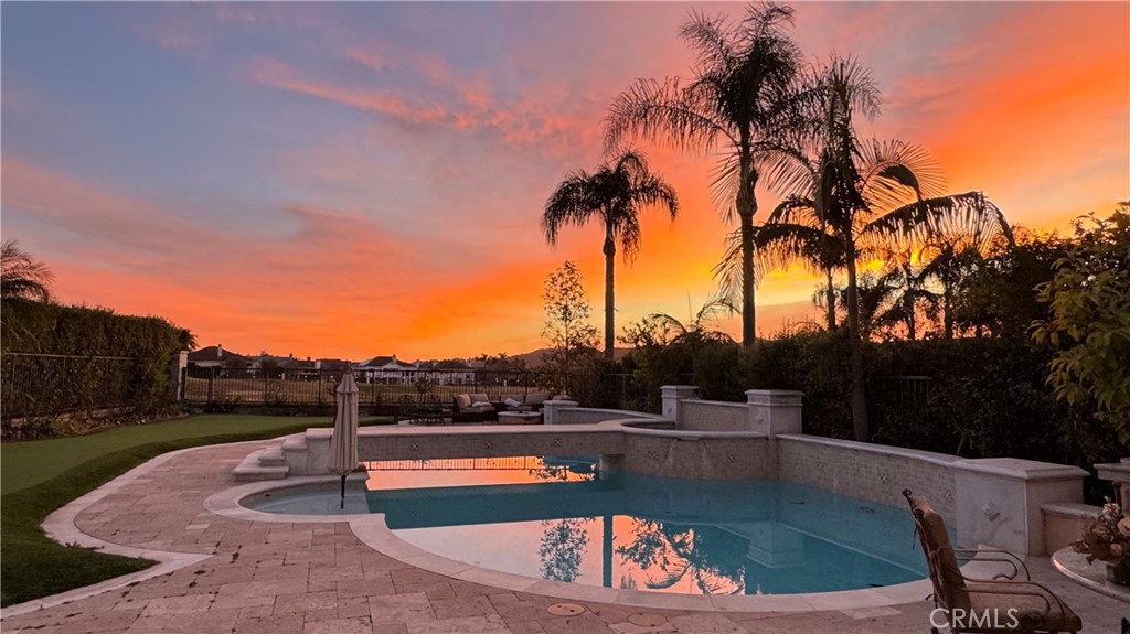 Experience unparalleled luxury at 30 Calle de Princesa in the gated community of Coto de Caza. Discover an extraordinary opportunity to own a meticulously upgraded estate with a pool. This exceptional residence, situated on a single-loaded cul-de-sac, boasts panoramic golf course views overlooking the 11th and 12th fairways. Upon entering, you are welcomed by a grand foyer that leads to a spacious living and dining area, showcasing soaring vaulted ceilings, elegant flooring, and custom trim. The upgraded chef-inspired kitchen is a masterpiece featuring a generous center island with quartz countertops, state-of-the-art appliances, and seamless integration with the expansive family room. The inviting family room is perfect for entertaining. The downstairs is complete with a private bedroom with an ensuite bathroom. Ascend the elegant staircase to the primary suite, offering sweeping golf course views, a private balcony, and a dedicated vanity area. The remodeled primary bathroom is a spa-like retreat, showcasing a stunning soaking tub, dual vanities, a separate shower, and a walk-in closet. A versatile bonus room provides additional entertainment or office space. Two secondary bedrooms, adjacent to a stylishly shared bathroom with dual sinks and a shower, complete the upper level. The resort-style backyard features a sparkling pool and spa, a built-in barbecue, a fire pit area with ample seating, and low-maintenance putting green, all while providing amazing views of the golf course. Property has owned solar. This luxury home in Coto de Caza offers an unparalleled lifestyle, combining premium finishes and a prime location. Enjoy the tranquility of a cul-de-sac setting within the highly sought-after East Point neighborhood. Enjoy access to world-class amenities Coto de Caza Golf and Racquet Club (optional memberships available), equestrian facilities, hiking trails, and more.
