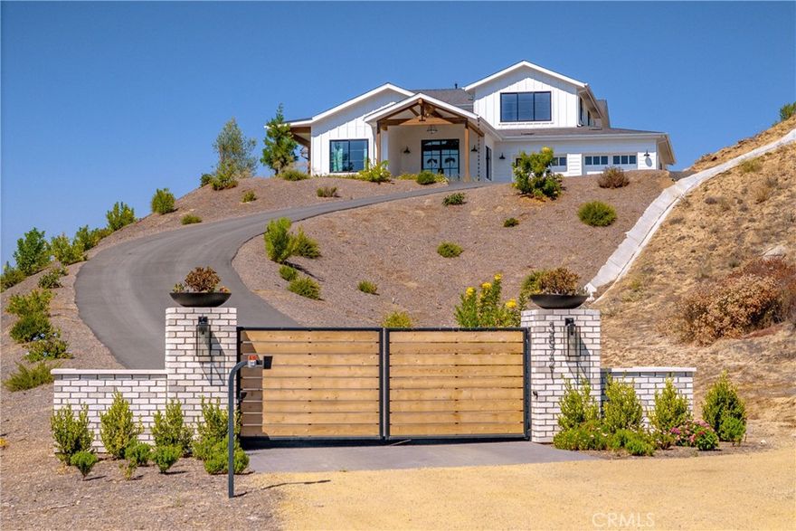 Welcome to this exquisite new custom-built home Nestled in the heart of beautiful Temecula wine country. Paid for solar and stunning views. This residence boasts 5 bedrooms, 4 bathrooms, and an expansive 3,811 square feet of meticulously designed living space. From the moment you approach, you are greeted by the charm of its unique architecture and allure.Enter through the grand front door, you step into a welcoming foyer adorned with elegant finishes and designer lighting, setting the tone for the luxurious modern atmosphere that permeates throughout the home. The open floor plan seamlessly connects the living spaces, creating an inviting and functional layout perfect for both everyday living and entertaining. The gourmet kitchen is a masterpiece, featuring custom cabinetry, large center island, sleek quatrz countertop. Whether you're a culinary enthusiast or enjoy casual family meals, this kitchen is sure to inspire your inner chef. The adjacent dining area provides a picturesque setting with large windows offering views of the surrounding vineyards and rolling hills. Living room is a cozy retreat, anchored by a stylish fireplace and bathed in natural light that filters through the strategically placed windows. Beautiful flooring, recessed lighting, and 8 ft interior doors add warmth and sophistication of the space. The down stairs master suite is a sanctuary of relaxation, boasting a spacious bedroom. The ensuite bathroom is a spa-like haven, complete with a soaking tub, a walk-in shower, and dual vanities, all finished with high-end materials and impeccable craftsmanship. The additional four bedrooms offer generous space, each uniquely designed to provide comfort and style. The accompanying bathrooms are appointed with modern fixtures and luxurious details. There is a loft upstairs perfect for a 2nd family room. The outdoor spaces are thoughtfully landscaped, with a covered patio for al fresco dining.  The backdrop of hills creates a tranquil ambiance that enhances the overall appeal of the property. This home not only offers a luxurious and comfortable lifestyle but also provides a unique connection to the beauty of wine-country living. With attention to detail at every turn, this residence is a testament to quality craftsmanship and timeless design, inviting you to experience the epitome of refined living in this enchanting locale. Close to the local wineries, top-rated schools, & freeway.