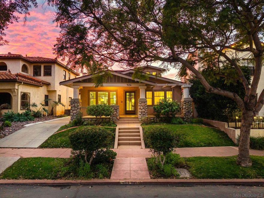 Nestled in the heart of North Mission Hills, this beautifully preserved 1922 Mission-style Craftsman blends timeless architectural character with thoughtful modern upgrades. From the moment you arrive, authentic details and curated finishes set the tone for a home that feels both historic and refined. The interior showcases a fully updated kitchen and baths, featuring custom cabinetry, bespoke moldings, and craftsmanship evident in every detail. Original windows remain throughout much of the home, adding warmth and character that newer construction simply can’t replicate. Comfort and efficiency are seamlessly integrated with owned solar, central air conditioning, a tankless water heater, and an electric vehicle charging station. The flexible floor plan offers two main-level bedrooms, one of which is currently styled as a family room and can easily be converted back to a bedroom. A beautifully updated bath serves the first floor. Upstairs, the primary retreat is its own sanctuary, complete with a fireplace, a spacious spa-like bath with separate soaking tub and shower, and refined finishes that honor the home’s original design—including a heated towel rack for a touch of everyday luxury. Indoor-outdoor living shines with a large covered patio, built-in barbecue, and a dramatic river-rock outdoor fireplace, creating the perfect setting for entertaining or quiet evenings at home. Custom draperies throughout add a layer of sophistication, while multiple fireplaces enhance the warmth and ambiance of the living spaces. Located just moments from dining and shopping!