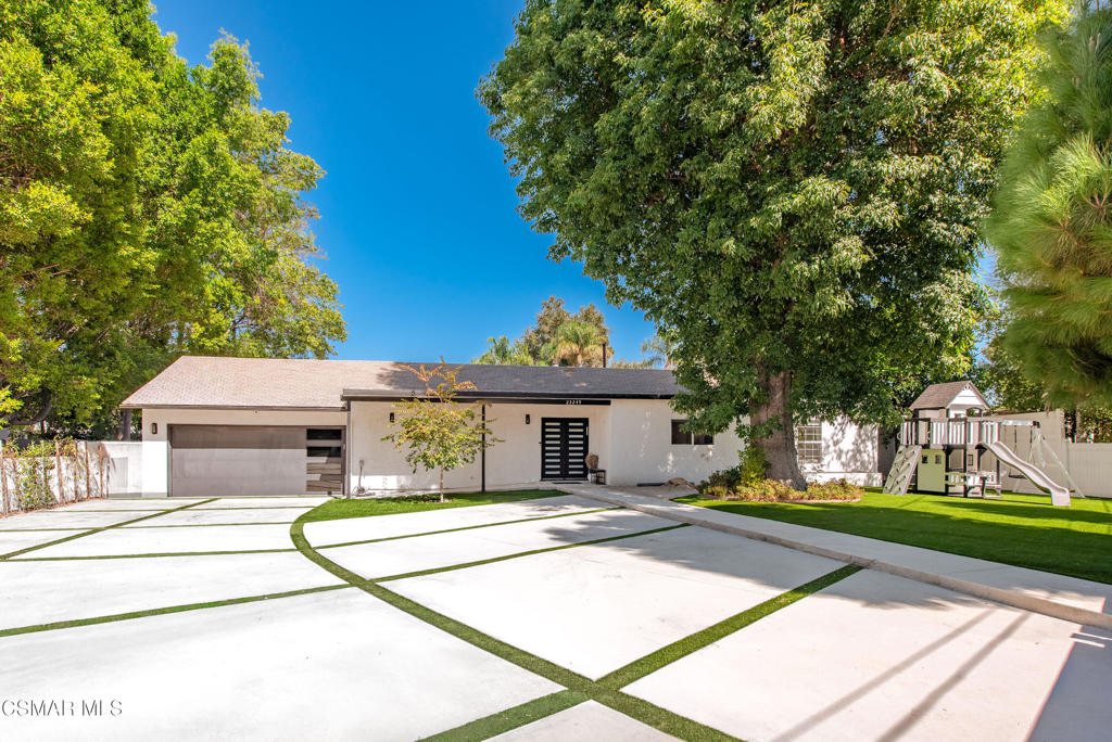 Stylish and move-in ready single-story home located in the desirable Walnut Acres neighborhood of Woodland Hills. Behind a modern gated entry and privacy fence, this updated property offers ample parking, a lush front yard with turf, and inviting curb appeal. Inside, enjoy an open floor plan filled with natural light, featuring a spacious living room with fireplace, dining area, and remodeled kitchen with a large island, granite countertops, custom cabinets, GE stainless steel appliances, and a private pantry. Double sliders open to a private backyard, perfect for entertaining or outdoor dining. The split layout includes two guest bedrooms and a full bath on one side, and a luxurious primary suite with fireplace, walk-in closet, and spa-like bathroom with a freestanding soaking tub, oversized shower, and dual vanities. Two additional bedrooms and a hall bath offer flexible space for a bedroom, home office, and/or playroom. The expansive backyard features a covered patio, multiple entertaining areas to make your own, and a large storage shed. Additional upgrades include recessed lighting, dual-pane windows, wood-like floors, and a two-car garage with laundry area. Enjoy modern comfort, privacy, and a prime location close to schools, parks, shopping, and dining.