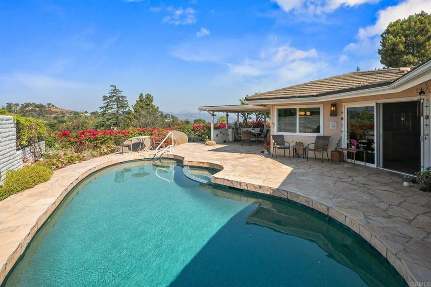 Perched high above the tree-lined streets of Mt. Helix’s coveted Horizon Hills, this custom mid-century ranch delivers a rare blend of single level living and 270° wraparound views. Thoughtfully cared for and extensively upgraded, this home is move-in ready and designed to make everyday living feel extraordinary. The ideal floor plan offers four spacious bedrooms and three full baths, and an abundance of living space which seamlessly connects to the flagstone back patio featuring a sparkling pebble-tech pool and a covered outdoor dining space; perfect for sunset gatherings or peaceful mornings surrounded by nature. Extensive upgrades ensure peace of mind and energy efficiency, including a 16-panel solar system with EV charging, a long-lasting metal roof, dual-paned windows, newer HVAC, fresh carpet, and a brand-new master-suite walk-in shower. Nearly every room frames spectacular views, while the elevated lot creates a sense of seclusion rarely found. El Jardin Verde is a small enclave of just 77 custom homes and is sought after for its quiet charm, tree-lined streets, expansive views, and lack of through-traffic; ideal for walking the dog or connecting with neighbors. With local dining, shopping, and freeway access just minutes away, this home offers serenity and convenience. Opportunities like this in Horizon Hills are rare, so schedule your private showing today and discover why this neighborhood is so highly sought-after.