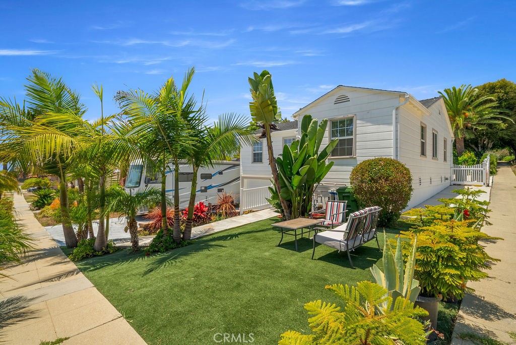 Nestled just a block away from the ocean in the coveted Palisades neighborhood of San Pedro, this beautifully remodeled home is a sanctuary of comfort and style. Boasting 4 spacious bedrooms and 3 elegant bathrooms, this residence offers an open floor plan bathed in natural light, making every corner of its 2,377 square feet feel bright and welcoming. The heart of the home is the eat-in kitchen, featuring a generous island with abundant cabinet space, ideal for culinary enthusiasts. Enjoy ocean views from the large primary suite or unwind in the newly added sauna. The home is equipped with a 220 AMP electric panel and Central AC to ensure modern conveniences are at your fingertips. Whether you're entertaining in the backyard, practicing your swing on the putting green, or relaxing in the spa, the outdoor spaces redefine luxury living. With a newer roof, double pane windows, and enlarged 2-car garage, plus RV parking, every detail has been thoughtfully considered. Downstairs, you'll find a 494 square foot Junior ADU with a private entrance and separate house number. This versatile space includes a kitchenette and laundry hookups and bathroom, perfect for guests or as a rental opportunity. Located just steps from the ocean, this home offers a unique blend of tranquility and convenience, making it a perfect retreat. Don’t miss the chance to make this ocean-view gem your own!