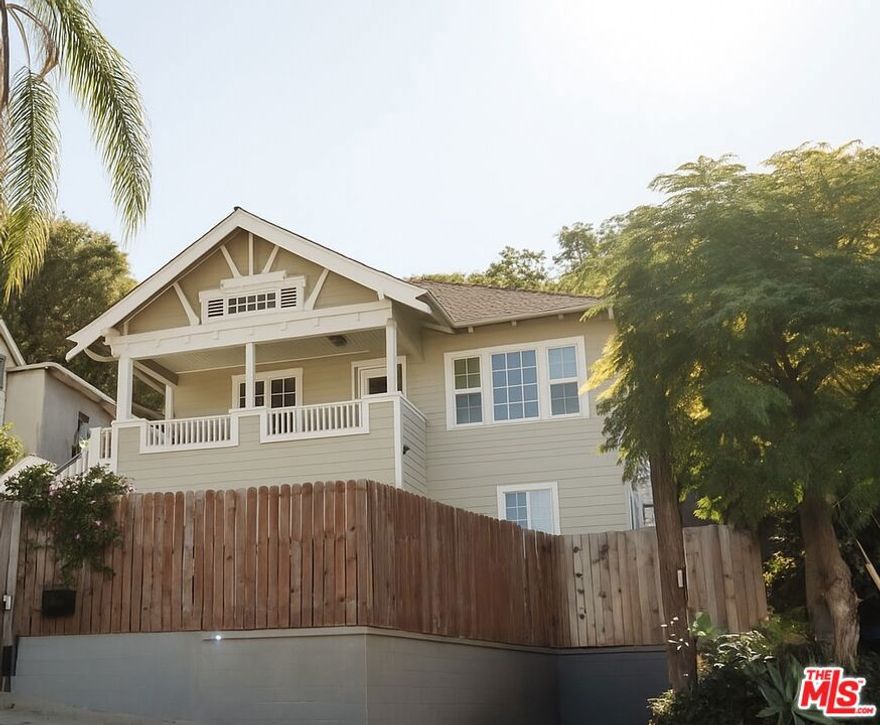 Private and gated, this charming El Sereno residence in University Hills offers warmth, character, and sweeping city and mountain views. The property features a 2 bed, 1.5 bath main home plus a separate lower-level studio with its own entrance, perfect for guests, extended family, or creative pursuits. Through the front gate, a welcoming porch and spacious patio set the tone for easy California living, ideal for morning coffee, relaxed evenings, or friendly gatherings. Inside, the bright and airy living room is filled with natural light and flows effortlessly into a generous dining area, creating the perfect setting for entertaining. The kitchen stands out with its green cabinetry, tiled countertops, and a cozy breakfast nook. A conveniently placed powder room and laundry area sit just off the kitchen, adding everyday practicality. Down the hall, two comfortable bedrooms offer ample closet space and share a centrally located bathroom with vintage charm. The lower level hosts a fully independent studio space, featuring a private side entrance, kitchenette, bathroom, and laundry area. With new flooring, updated countertops, and modern lighting, this flexible space can serve as a guest suite or personal workspace. Out back, the yard is a true retreat with fruit trees, a raised garden bed, a firepit, and a pergola perfect for dining al fresco. Two storage sheds and a one-car driveway provide added function to this inviting property. Located near Ernest E. Debs Park and Ascot Hills Park for hiking and nature walks, and just minutes from local favorites like Holy Grounds Coffee, Evil Cooks, and Lil' East Coffee, this El Sereno gem offers peaceful living with easy access to the best of the neighborhood.