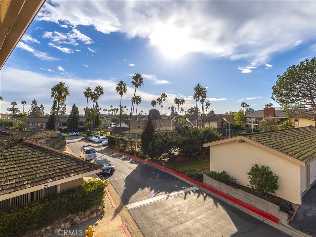 PRICE REDUCTION CREATE SUPER VALUE. This sunny and bright unit sits atop the highest point in New Horizon's. The South side of the unit is open to views of the PV hills and the Tennis/pickle ball court. The North side view is the green belt area and large tree. Welcome home to this charming, 2-bedroom, upper corner unit at New Horizons South Bay. Featuring an open entry with a large living room, enhanced by a wood burning fireplace. This well-designed interior living space offers comfort and two spacious outdoor balconies. But the appeal doesn't stop there; this 55+ senior living community boasts a plethora of amenities that enhance your lifestyle. Imagine having access to not one, but two sparkling pools and Spa for those sun-soaked days, a sports center with a well-equipped gym, his and hers dry sauna, ping pong room, craft shops including the popular ceramic hobby shop. Activities at the Spors Center include the Tennis/Pickle Ball court. The heart of the community is the Clubhouse for gatherings, many planned social clubs and events. The Community Room and Lounge are available for Owners private functions. For those who enjoy golf, the 9-hole golf course, putting green, driving cage and picnic area is accessible from the Club House. These are just a few of the many amenities waiting for you here. New Horizons is more than just a place to live; it's a place to thrive and enjoy the good life.