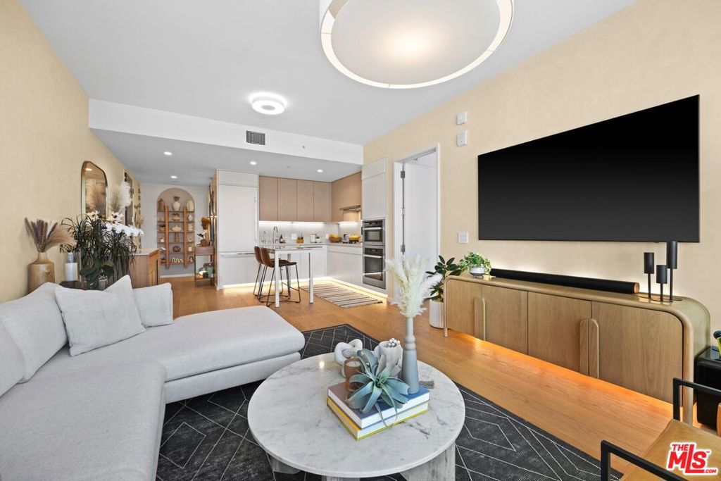 Experience the epitome of luxury living at Metropolis, located in the coveted South Park neighborhood of Downtown Los Angeles. This exceptional 1-bedroom, 2-bathroom residence on the 21st floor offers some of the most breathtaking views in the building, showcasing the iconic Hollywood Sign, the scenic Hollywood Hills, stunning sunsets, and the glittering city lights below. Elegantly designed with a focus on both style and function, this sophisticated unit has been meticulously curated since its 2022 debut. Highlights include bespoke upgrades such as custom closets in the primary suite, a tailored linen closet in the powder room, automated window coverings, a sleek glass shower enclosure, and a state-of-the-art reverse osmosis water filtration system with instant hot water. Unit 2101 enjoys an unparalleled location compared to other units, being just steps from the exclusive Skydeck, perched on the 21st floor. This private oasis offers 360-degree panoramic views of the city, complete with fire pits, an outdoor kitchen, and ample space for quiet reflection or work.Beyond your doorstep, Metropolis boasts a vast array of world-class amenities, including over 2 acres of meticulously landscaped outdoor space on the 11th floor the largest private elevated garden in downtown Los Angeles. Unwind in lush surroundings with outdoor yoga, relax in a cabana by the pool, or bask in the tranquility of the palm-lined oasis. The 24-hour fitness center, along with private saunas and steam rooms, promises wellness at your fingertips.Indulge in the seamless service offered by the 24-hour concierge and security, ensuring both convenience and peace of mind. 1 parking space included with purchase, additional parking is available for rent, and the building features EV charging stations on every floor. Unit 2101 represents the pinnacle of luxury in one of downtown's most prestigious buildings. Live where comfort, convenience, and style converge.