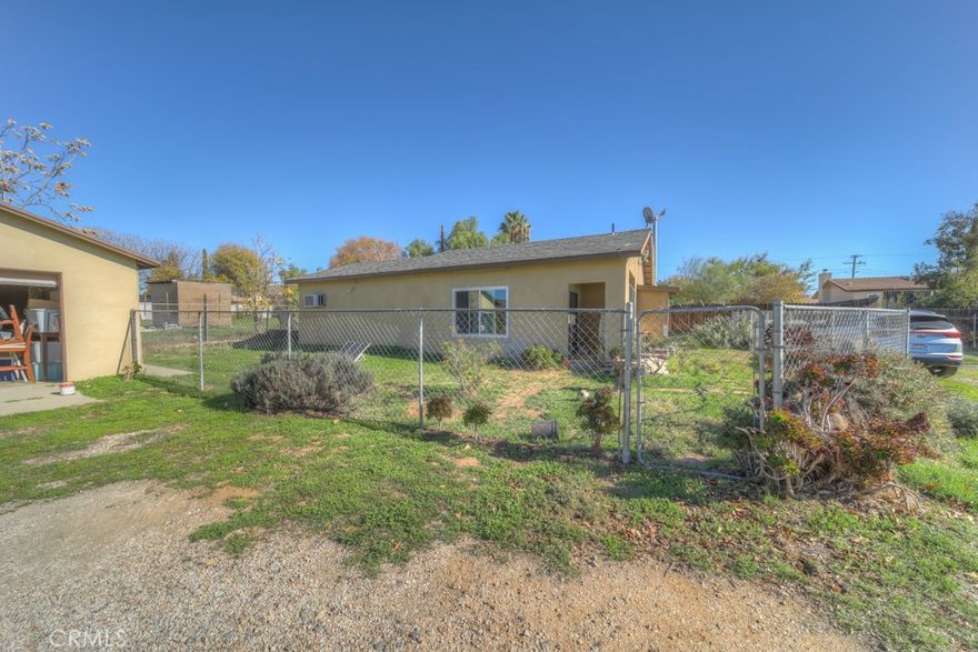 Private Setting on Nearly 1/5 Acre — Spacious Lot, Detached Garage, and Great North-of-Freeway Location
, this home offers a quiet setting, tucked away from the main road with no neighbor on one side and a fully fenced yard for added privacy.

A long driveway provides generous parking for multiple vehicles, plus room for your RV, boat, trailers, or work equipment, all leading to a detached 2-car garage—perfect for storage, hobbies, or a workshop setup.

Inside, the home features tile flooring throughout, offering durability, easy maintenance, and a clean, cohesive look. The kitchen includes granite countertops and cabinet space, and the home has a sliding patio door. Bedrooms are comfortably sized, and the functional layout provides a great foundation for your personal upgrades and finishing touches, the outdoor space offers plenty of potential—garden areas, pets, play space, or future enhancements.

Conveniently close to freeway access, shopping, dining, and schools, this home is ideal for a first-time buyer, downsizer, investor, or anyone seeking value, space, and privacy at an affordable price.