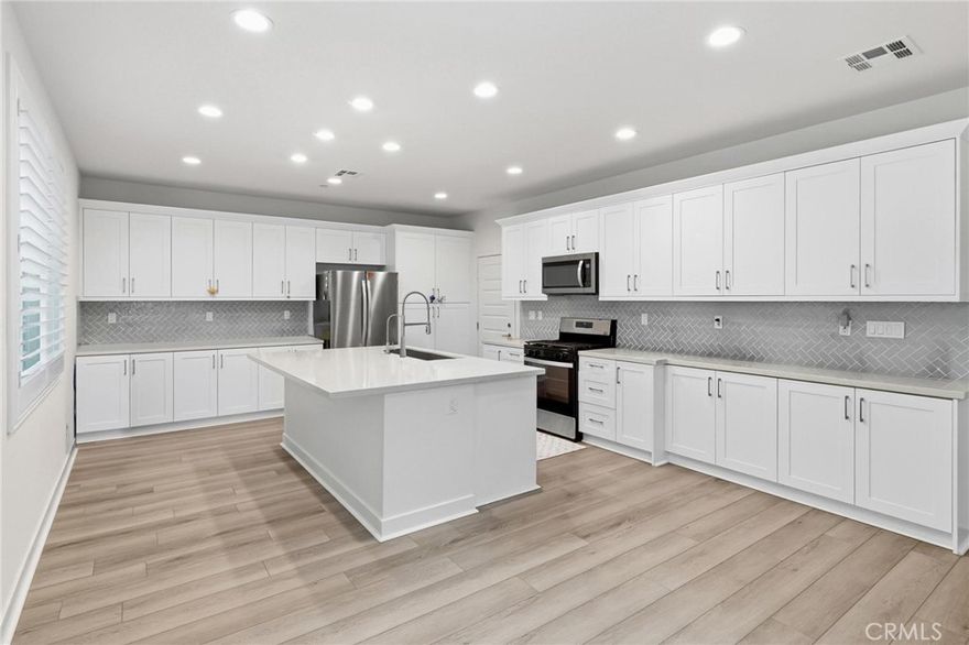 Welcome to 4217 S Heather Privado, a beautifully maintained two-story home located at the end of a quiet cul-de-sac in the desirable Ontario Ranch community. Built in 2024, this 4-bedroom, 3.5-bathroom home spans 2,528 square feet and offers a functional layout. The main floor features a bedroom with an en-suite bath, perfect for guests or multi-generational living. The spacious living room opens to the kitchen and dining area. The kitchen showcases white cabinetry, stainless steel appliances, and subway tile backsplash. The backyard features a low-maintenance paver patio, ideal for outdoor dining or relaxing. Upstairs, a large loft provides flexible space for a second living area, home office, or playroom. The primary suite includes a walk-in closet, dual vanity, soaking tub, and walk-in shower. Additional highlights includes luxury vinyl plank flooring, custom shutters, recessed lighting, and a direct-access two-car garage. Conveniently located near Costco, 99 Ranch Market, and a variety of shopping and dining options, with easy access to the 15 and 60 freeways. Located within the Chaffey Joint Union High School District.