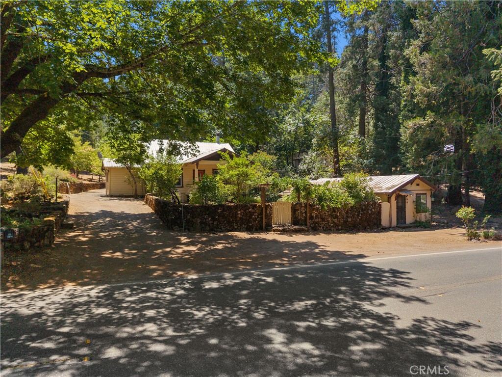 Charming Historic Craftsman home built by the Salmina Family on 1.89 acres offers 2 separate homes on two separate parcels. On 10899 Highway 175 sits the main home with 2 bedrooms plus a dressing room in between the bedrooms that could serve as a home office. The spacious bathroom has a large stall shower and plenty of storage. The finished attic, easily accessed by carpeted stairs, features built-in shelving for books, arts & crafts with plenty of space for kids or guest quarters. The kitchen features a propane range, walk-in pantry, built-in cabinets in the dining area with windows that look out onto the back property. The separate laundry/utility room has a wall of storage cabinets, washer & dryer, & upright freezer. The separate workshop building, with electricity, features multiple drawers, cabinets & shelving for your DYI projects. On 10897 Highway 175 sits a cozy cottage with 1 bedroom and a bath, kitchen & living rooms which is presently tenant occupied but could serve as a mother-in-law unit.
The park like manicured grounds offer several areas to relax, BBQ and entertain. You can take a ride up the road to the Loch Lomond pool for a swim & lunch or play a round of golf at Adams Springs golf course where you can also have a delicious meal! Just a few of the many activities to enjoy in Lake County!