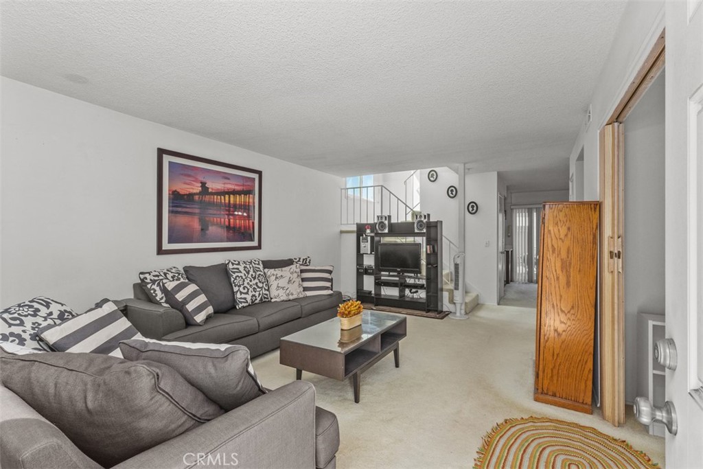 Nestled in the cozy community of Cape Huntington, this 4bd, 2ba townhome is just 2.5 miles from the famed beaches of Huntington Beach. Step inside and you are greeted to an open, airy layout filled with an abundance of natural light. The first floor has a bedroom ensuite and there are an additional three bedrooms on the second floor. This darling home is an end unit that has a large outside patio, along with a balcony upstairs that showcases gorgeous sunset views. The nearby private association pool is so inviting; you'll be tempted to take a dip. This is a wonderful opportunity to own a home in the community of Cape Huntington, as they very rarely come to market. With a little love this could be your new home.