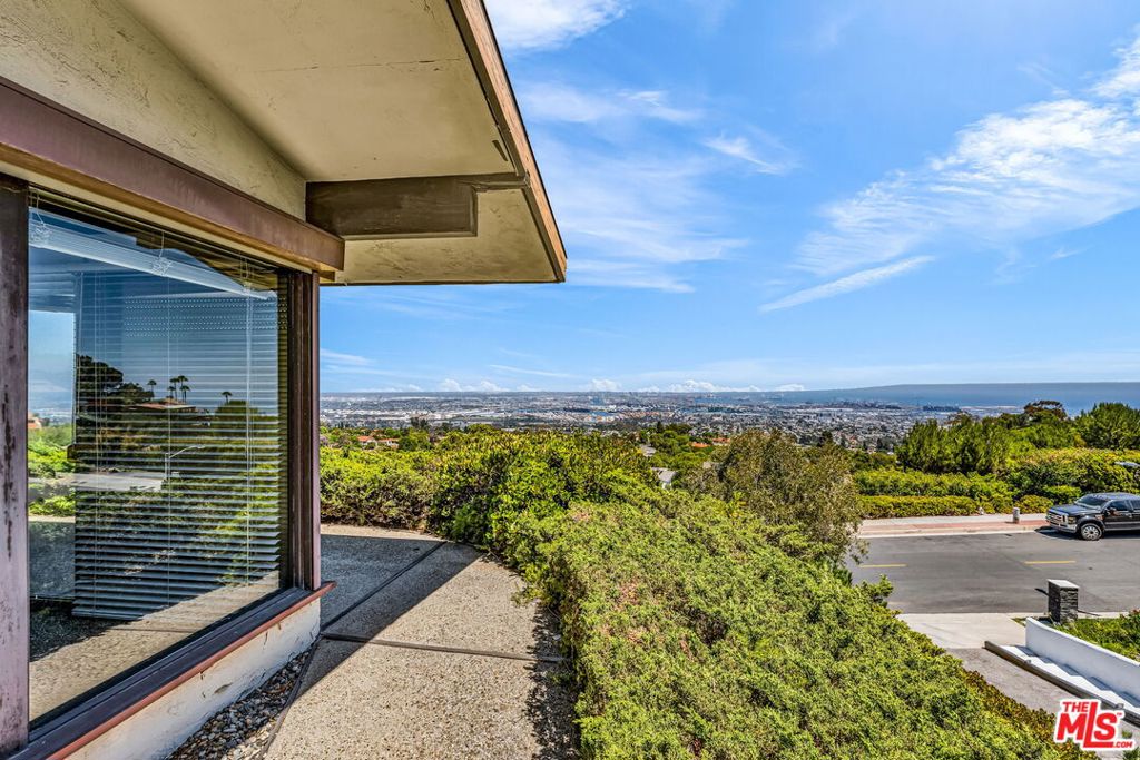 Set high in the coveted hills of Rancho Palos Verdes, this original-condition mid-century classic offers 3 bedrooms, 2 bathrooms, plus a dedicated office that could serve as a 4th bedroom. The home features 2,244 sq. ft. of living space on an expansive 16,720 sq. ft. lot. Walls of glass and a timeless open layout highlight panoramic, unobstructed views stretching across the Pacific Ocean, Catalina Island, and the dazzling city lights beyond. Located within the acclaimed Palos Verdes Peninsula Unified School District, the property is ideally positioned just minutes from Terranea Resort, scenic bluff-top trails, world-class golf, and premier dining and shopping. Rarely available, this coastal gem presents a unique opportunity to restore or reimagine a true Palos Verdes classic while embracing the quintessential Southern California lifestyle.
