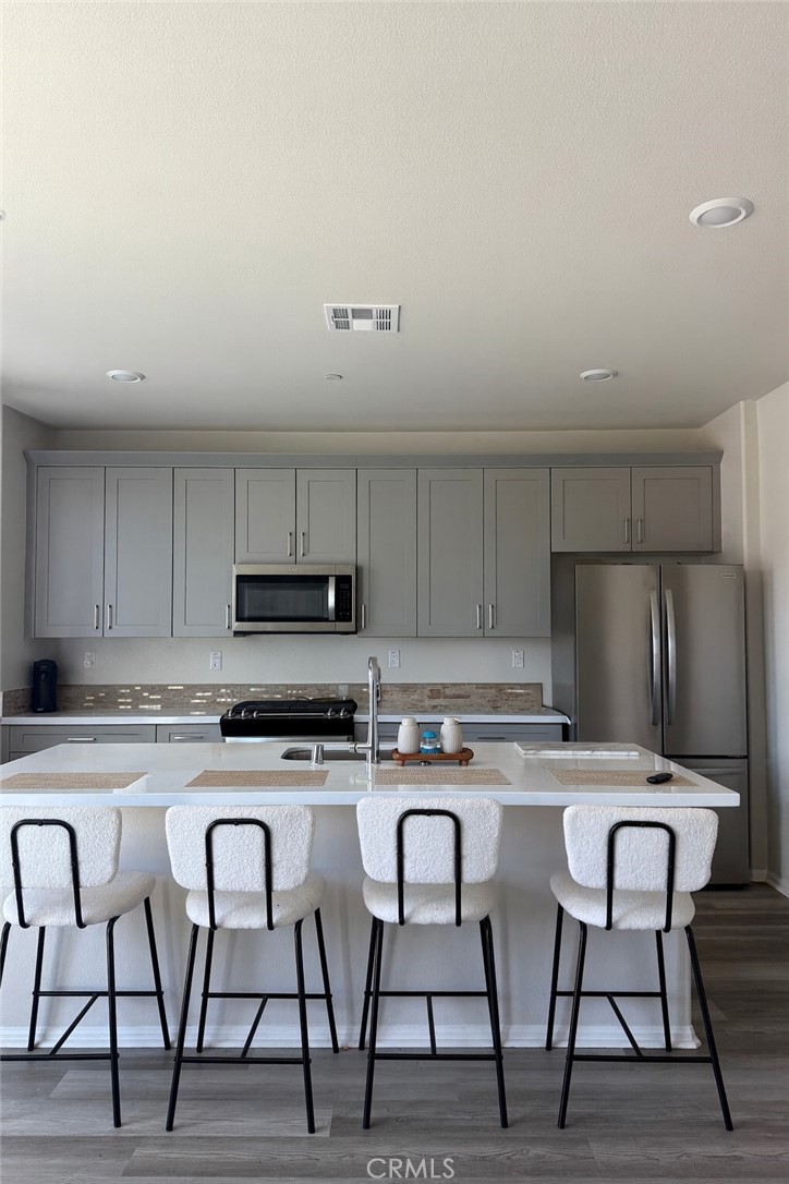 Welcome to this newly built 3-bedroom home with solar included, nestled in the beautiful Tierra Del Sol community of Winchester! From the moment you step inside, you’re greeted by stunning plank flooring, soaring high ceilings, and a thoughtfully designed open floor plan that flows seamlessly from room to room. At the entryway hallway, you’ll find a conveniently located half bathroom as well as storage. The kitchen is the heart of this home, featuring quartz countertops, shaker style cabinets, a spacious pantry, upgraded appliances, and a center island that opens effortlessly to the light filled family room. This inviting space is bathed in natural light, creating a warm and welcoming atmosphere. As you head upstairs, you’ll discover a versatile loft/landing area, perfect for a work or study space. Each of the generously sized bedrooms features plush carpet flooring. The primary bedroom is a true retreat, offering both serenity and privacy. Its en-suite bathroom includes dual sinks, a walk-in shower, and a spacious walk-in closet. There are 2 additional bedrooms with a guest bathroom. Convenience is key, and the second-floor laundry room makes everyday tasks a breeze. This home features energy-efficient features, including solar panels, tankless water heater, and water softener system. Smart home equipped with MyQ functionality and EV charging connectivity that help cut down on utility bills. Located in the award-winning Temecula school district. Just a short stroll to the end of the street, you’ll find a tot lot and a picnic area, perfect for enjoying the outdoors. Don’t miss the chance to be the first to call this beautiful home yours.