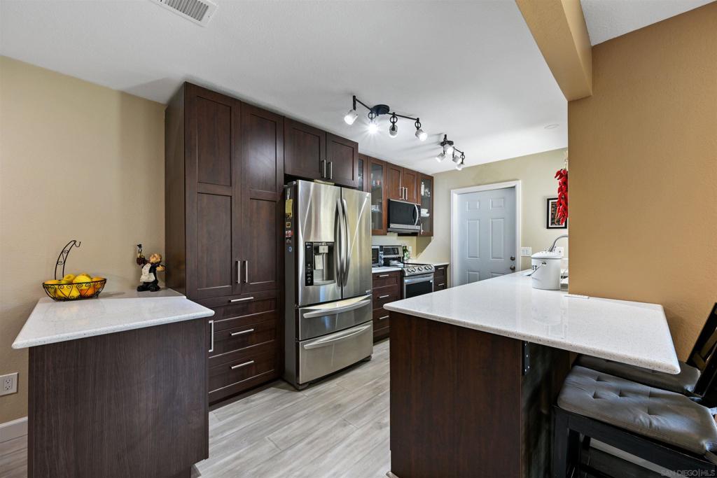 Welcome to one of Poway’s most desirable neighborhoods! Tucked away on a quiet cul-de-sac, this beautifully updated home offers comfort, style, and unbeatable location — just minutes from Old Poway Park and all that central Poway has to offer. Enter to find top-of-the-line laminate flooring that’s perfect for pets, with plush carpeting in the bedrooms for added comfort. Enjoy fresh interior paint throughout and a newly tiled fireplace that adds a modern touch to the living space. The updated kitchen features extra cabinet space, making organization a breeze, while the remodeled bathrooms throughout provide a sleek, contemporary feel. The custom primary suite is a standout, boasting dual sinks, a spacious shower, vanity area, and custom closet doors for a truly personalized retreat. Outdoor living is easy with a doggie door leading to a private patio complete with hardscape and turf — ideal for low-maintenance entertaining or relaxing evenings. You’ll also love the direct access to your two-car garage, a rare feature in this community. Additional highlights include dual-pane windows for energy efficiency, central A/C for year-round comfort, and a short distance to the community pool and grass common areas. New roofs were installed throughout the community in 2024 by the HOA. This VA and FHA-approved community makes homeownership accessible and secure. Don’t miss your chance to own in this prime Poway location!